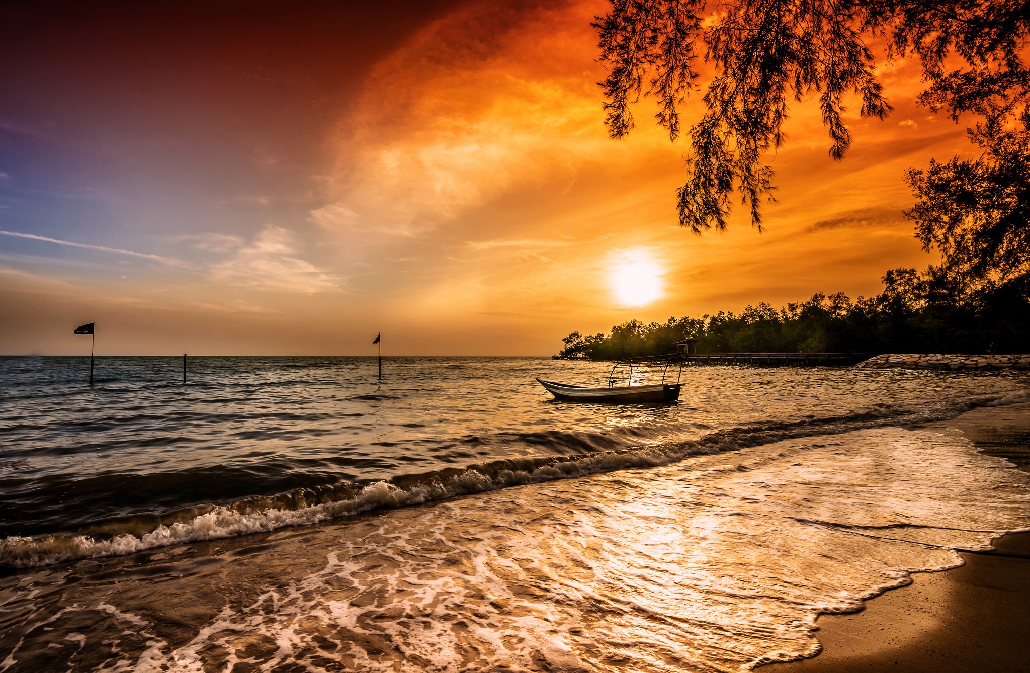 Sunset over the sea with a boat and flags HD Wallpaper