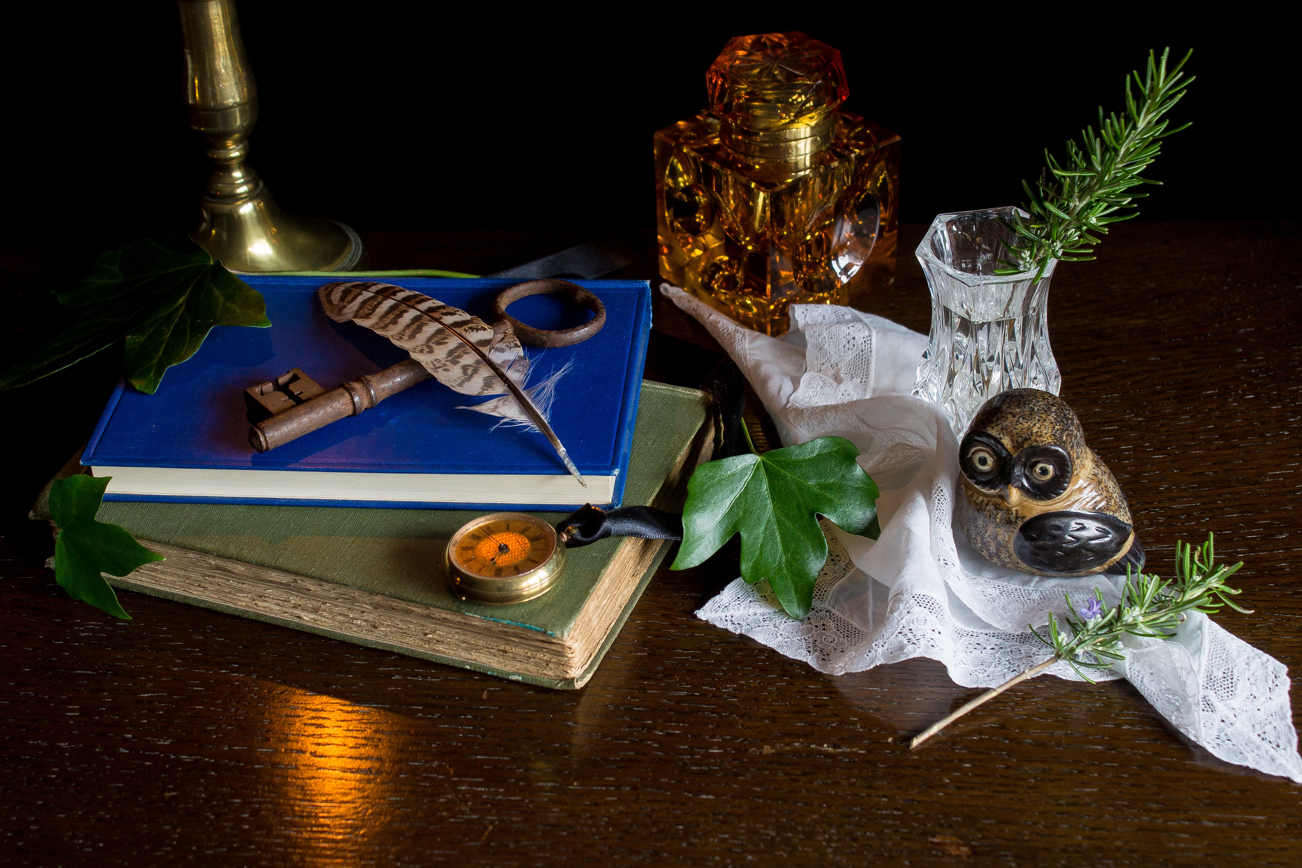 Still-life with book, key, feather, and owl figurine HD Wallpaper