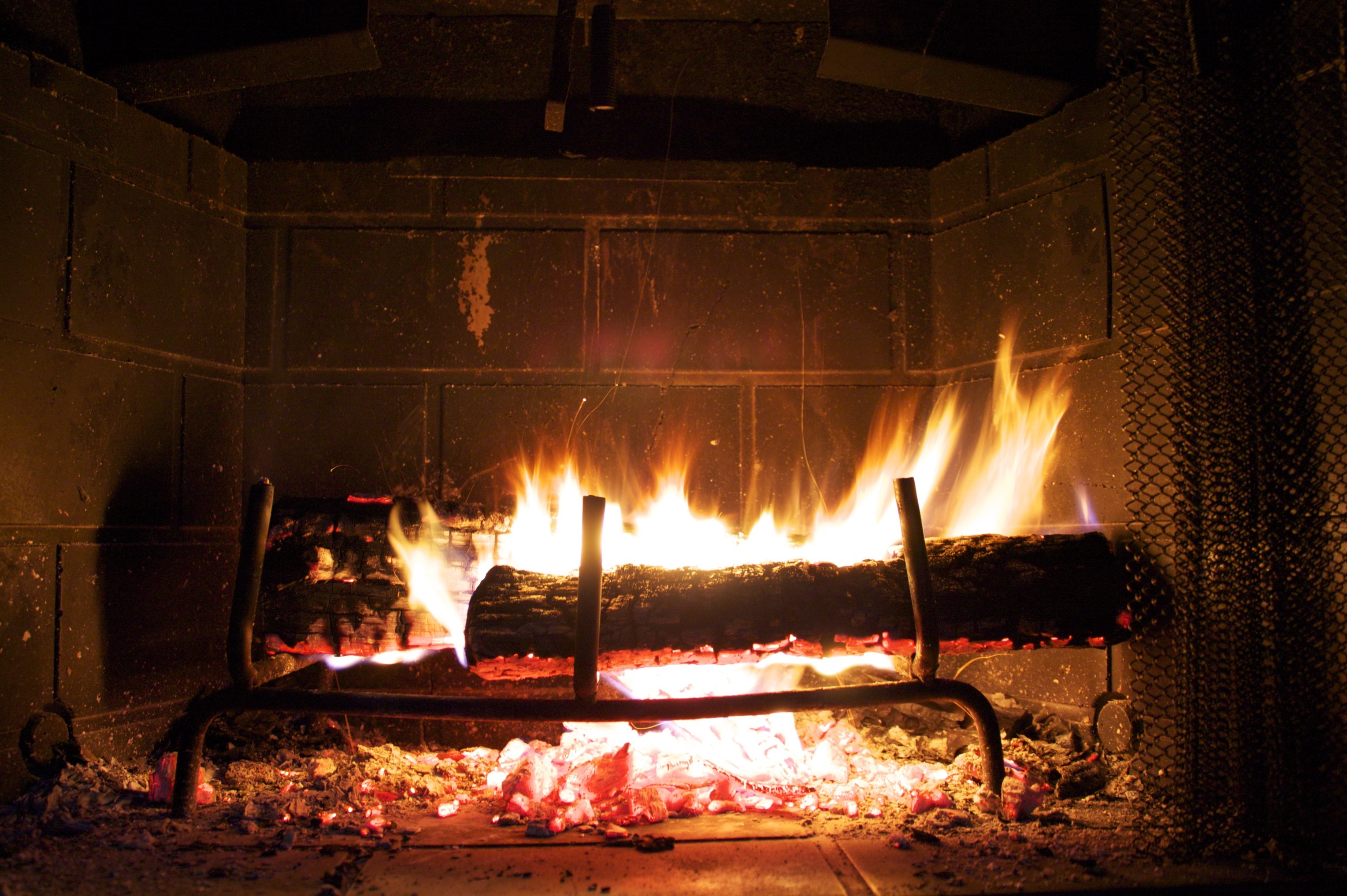 Fire burning in a fireplace HD Wallpaper