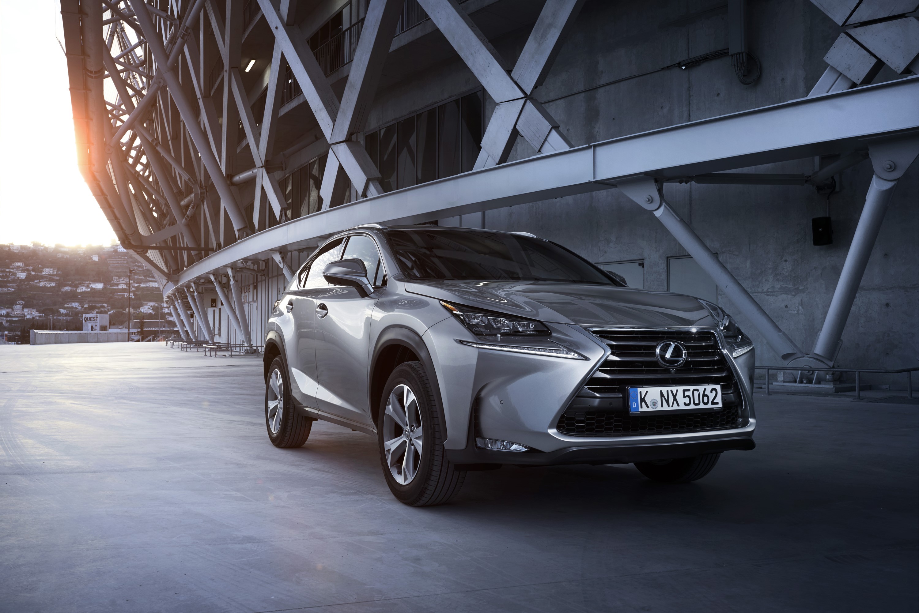 Silver Lexus NX 300 parked near a modern building HD Wallpaper