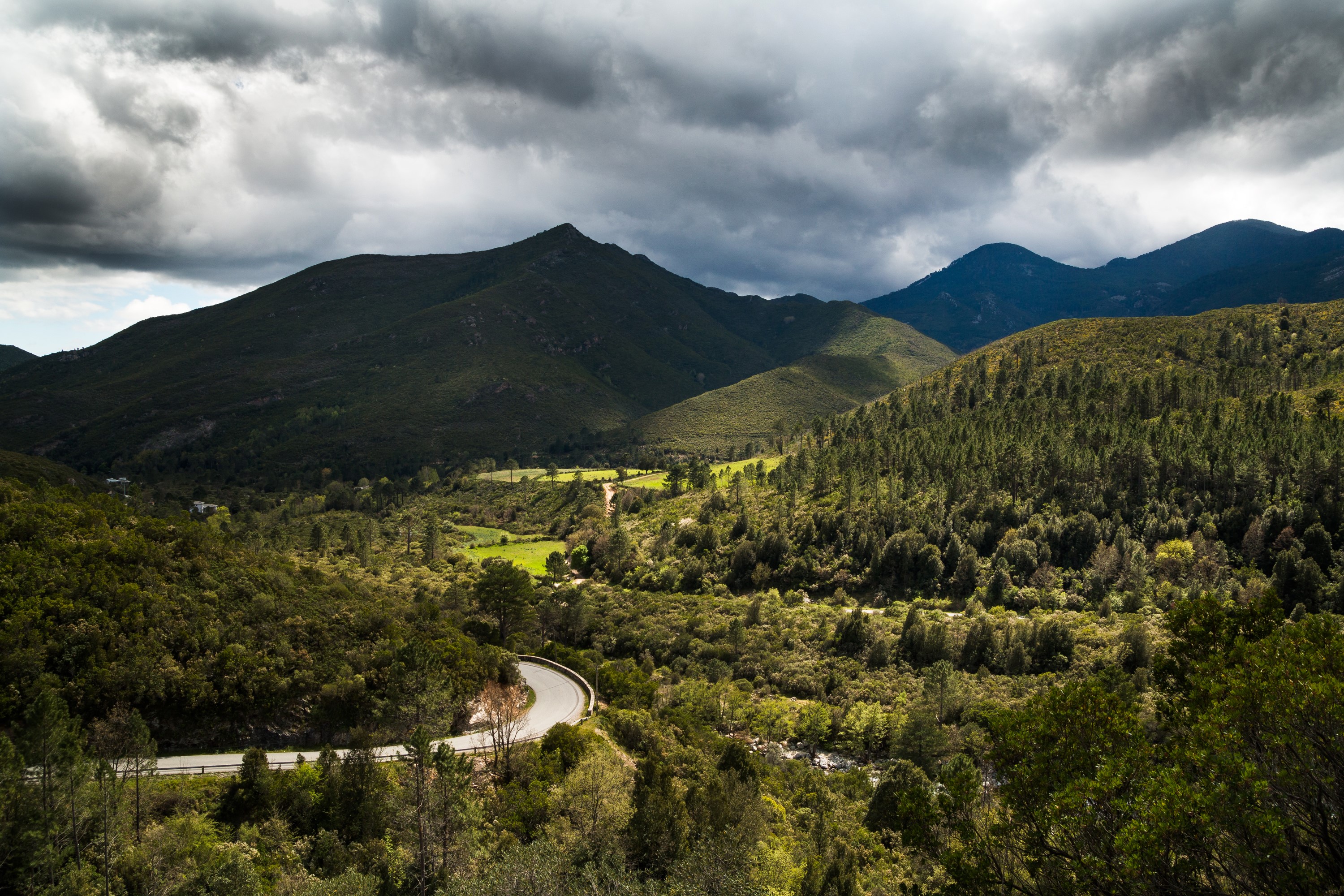 Mountainous landscape with winding road in Corsica, France HD Wallpaper