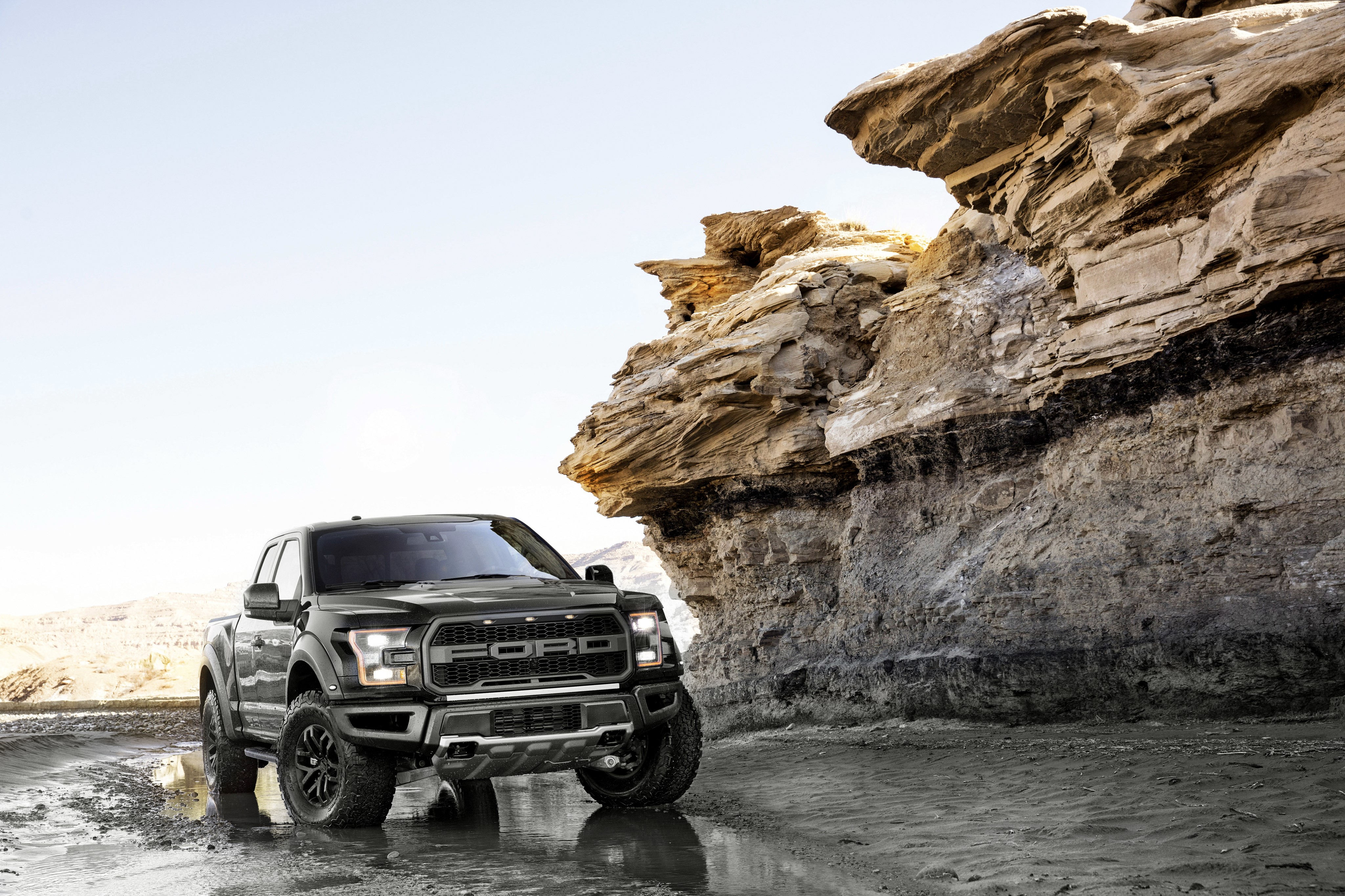 4K Ford F-150 Raptor in a rocky desert HD Wallpaper