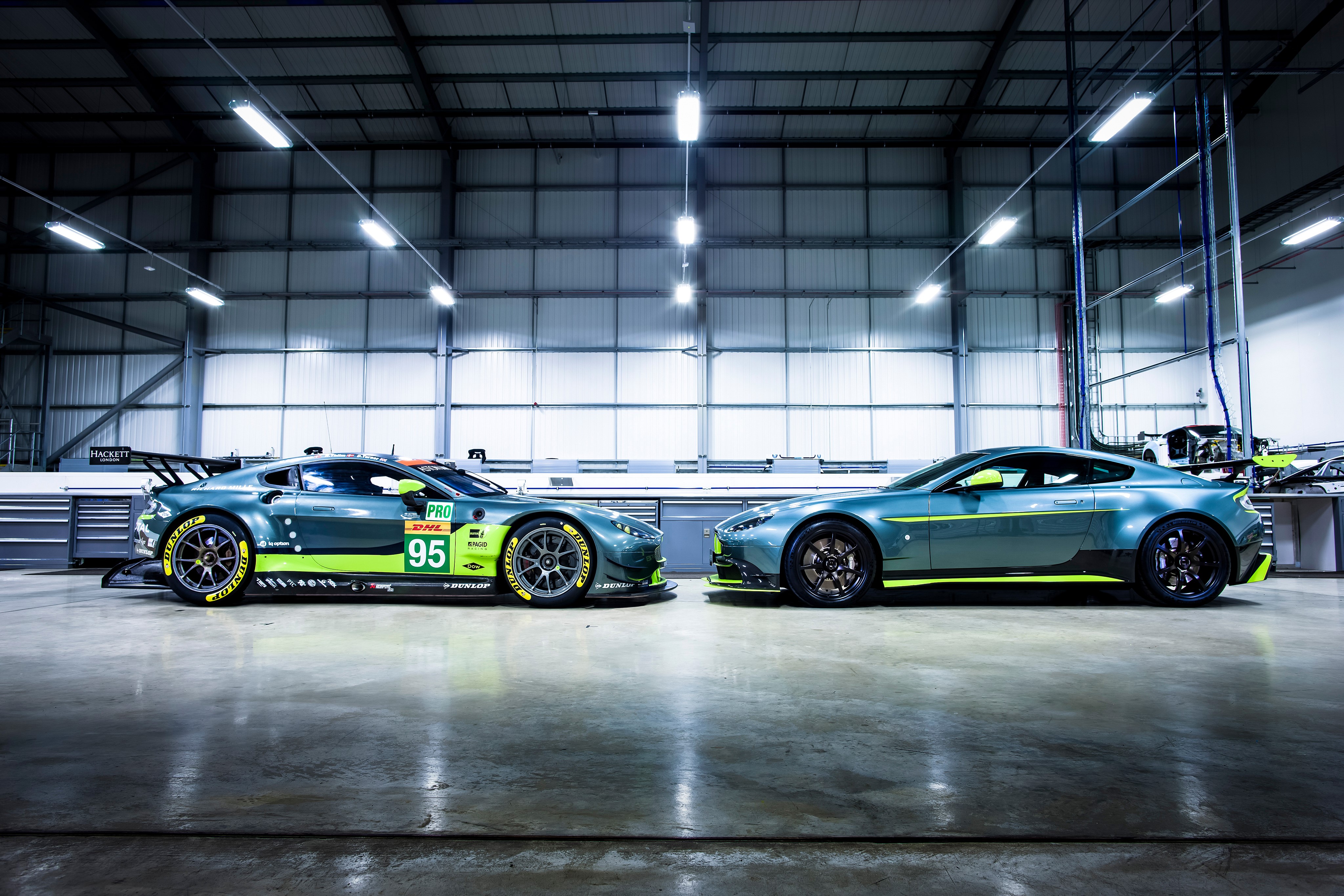 Two Aston Martin Vantage GT8 cars in a garage HD Wallpaper
