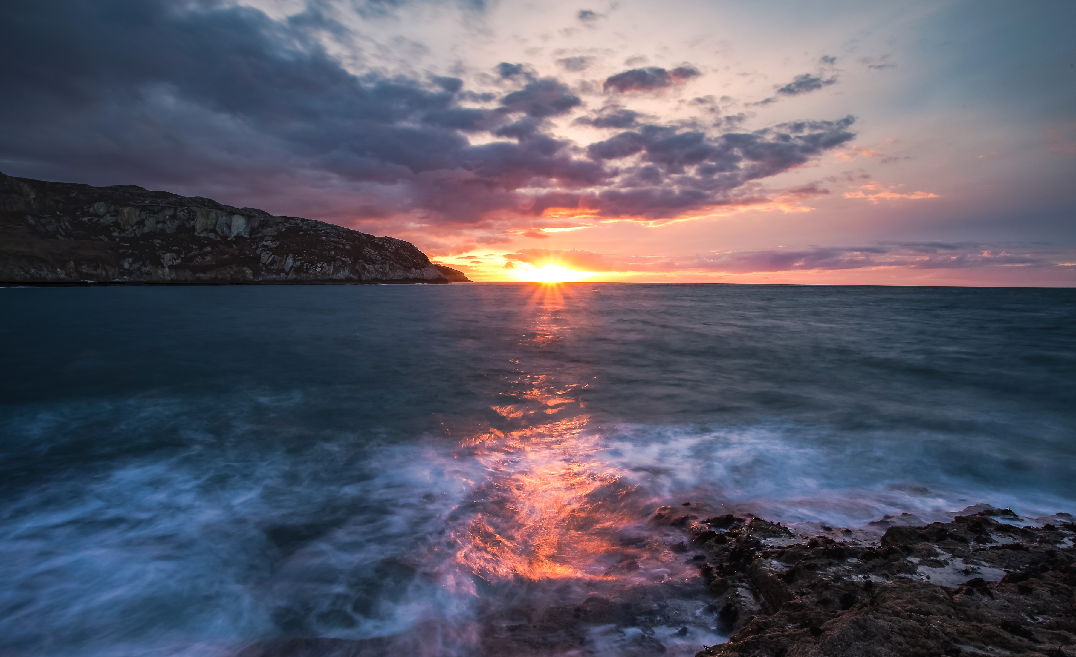 Sunset over the sea with rocky shore HD Wallpaper