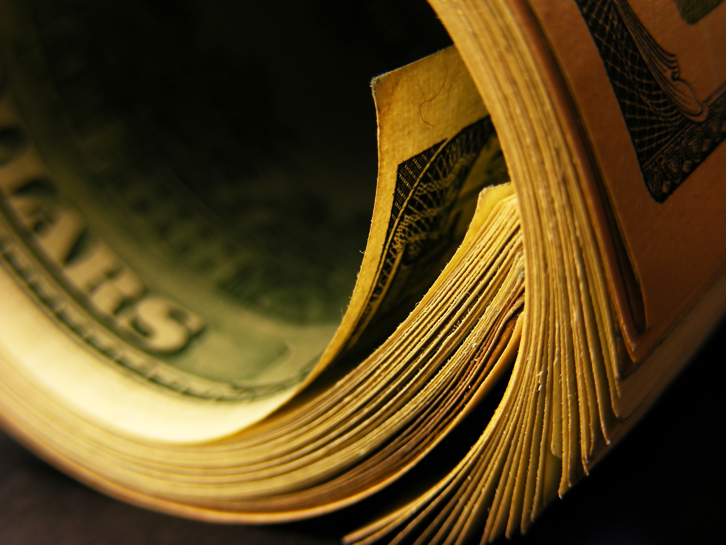 Close-up of a roll of US Dollar banknotes HD Wallpaper