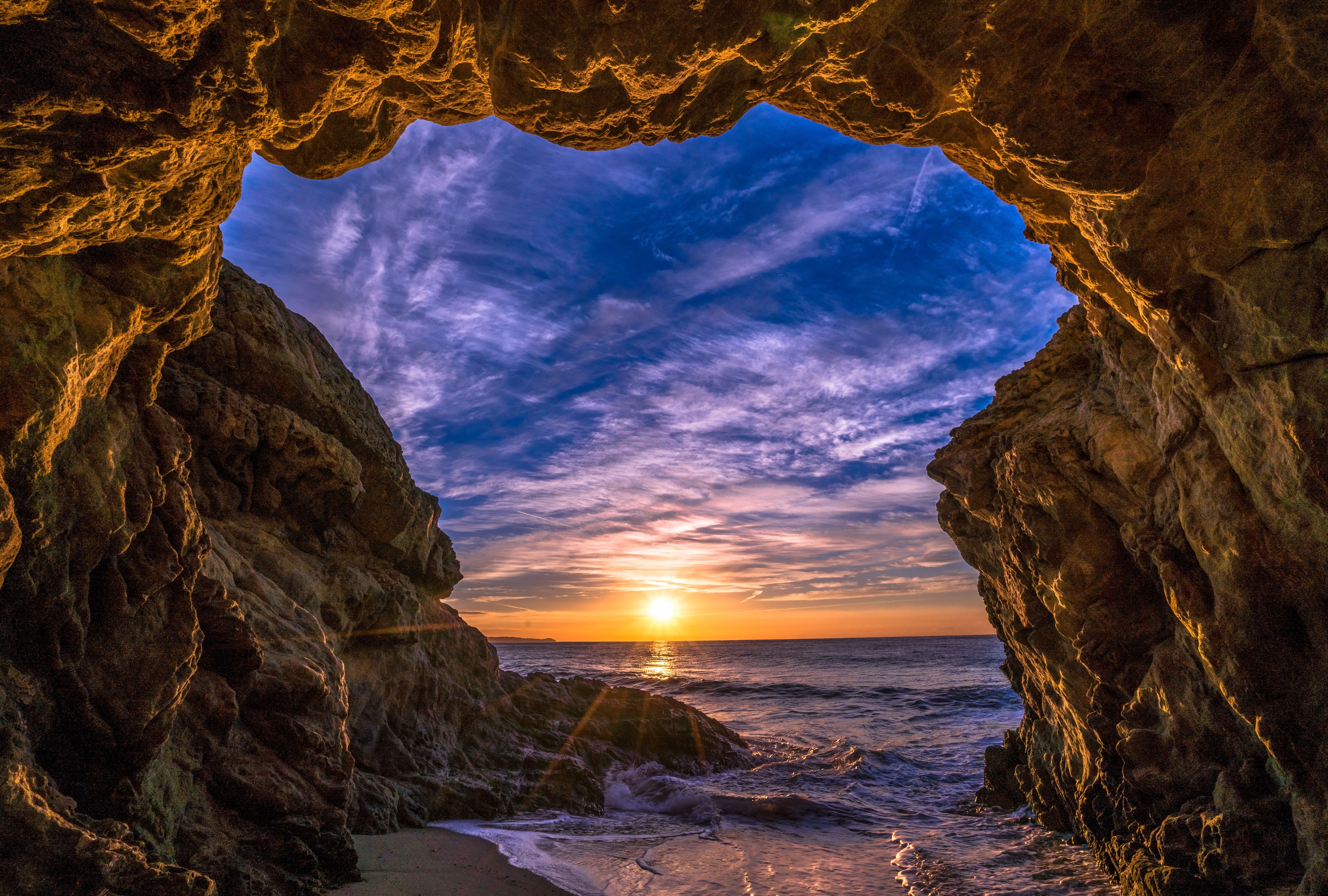 Sunset viewed from a cave entrance in Malibu, USA HD Wallpaper