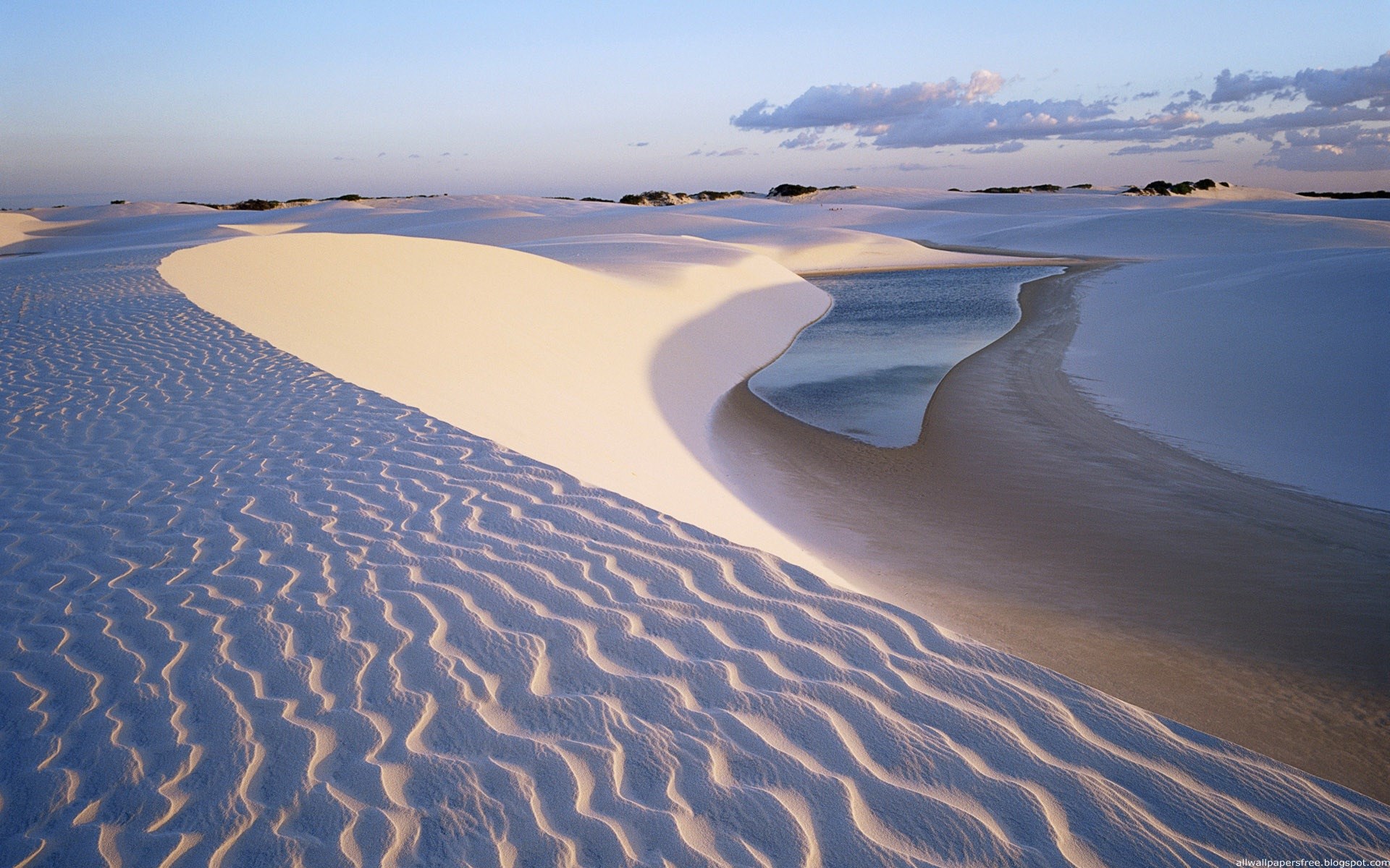 Desert dunes with a small body of water HD Wallpaper