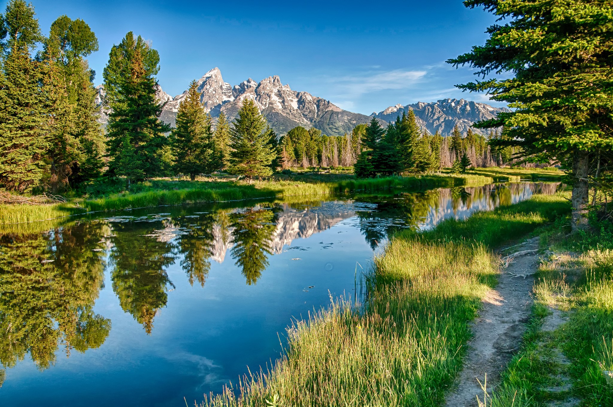 Mountains reflected in a river with trees HD Wallpaper