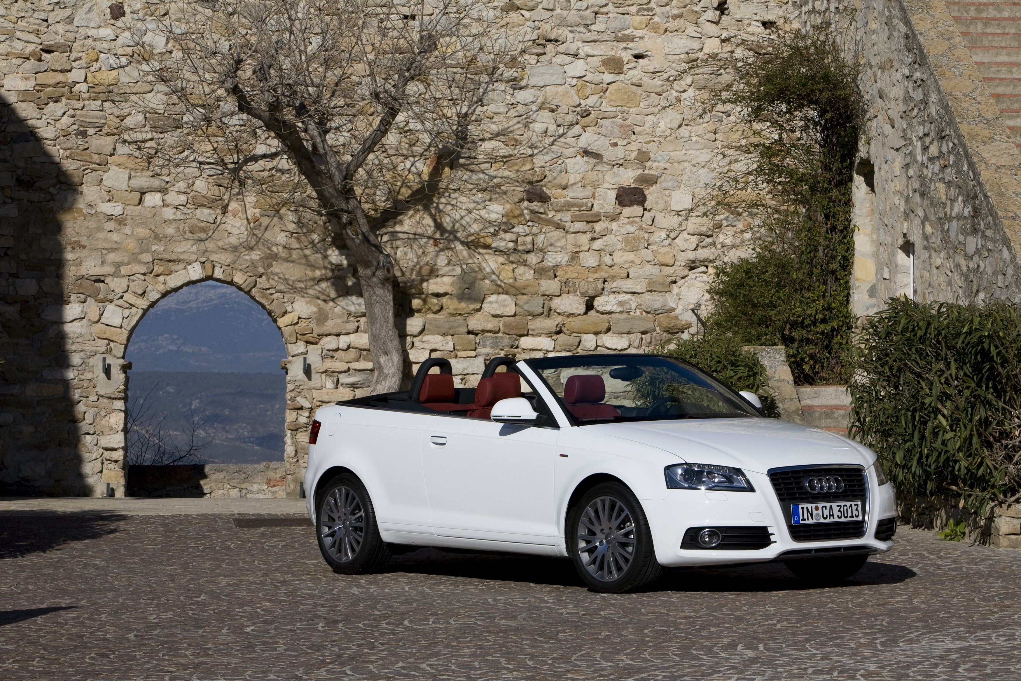 White Audi A3 Cabriolet parked near stone wall HD Wallpaper
