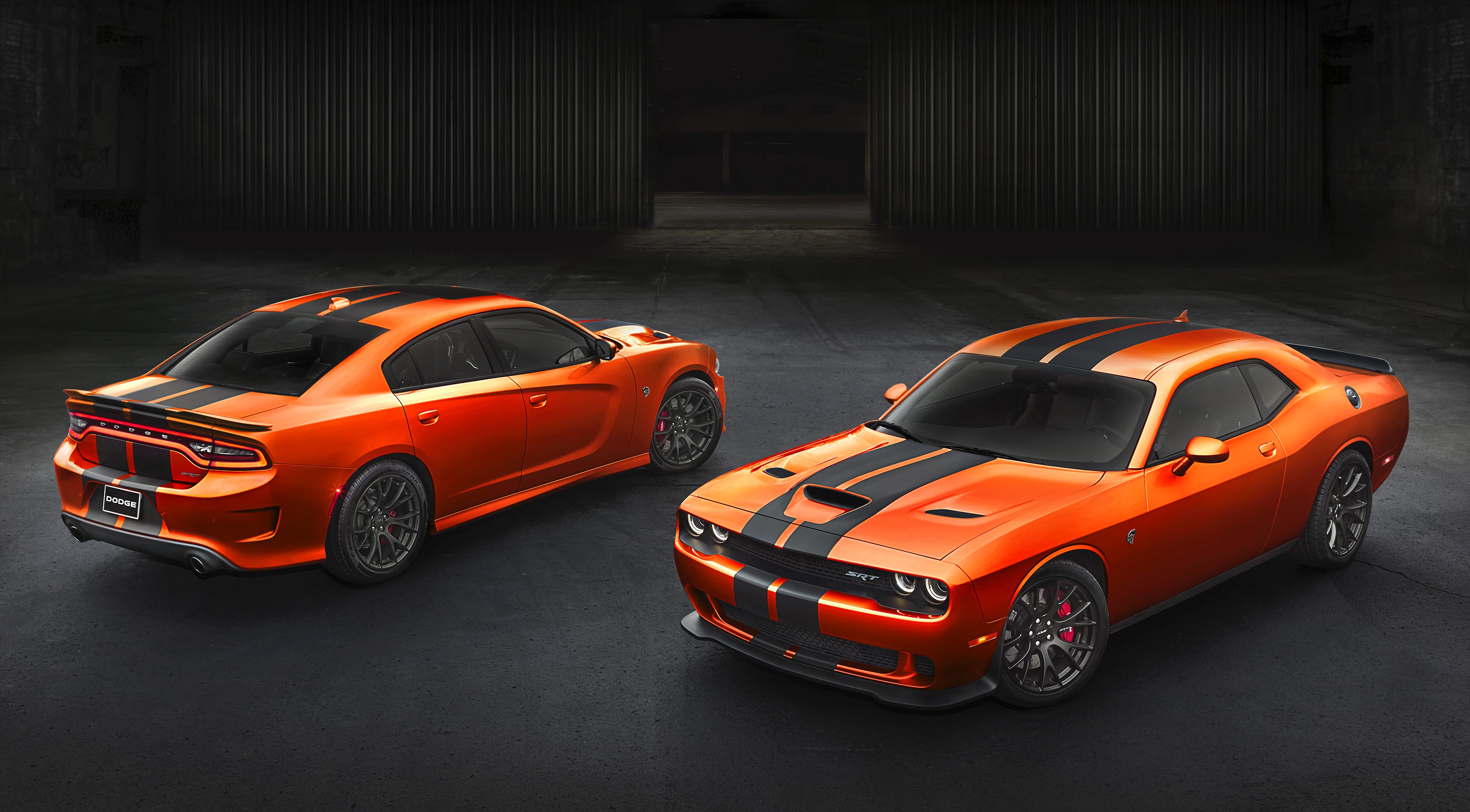 Two orange Dodge Charger SRT Hellcat cars with black stripes HD Wallpaper
