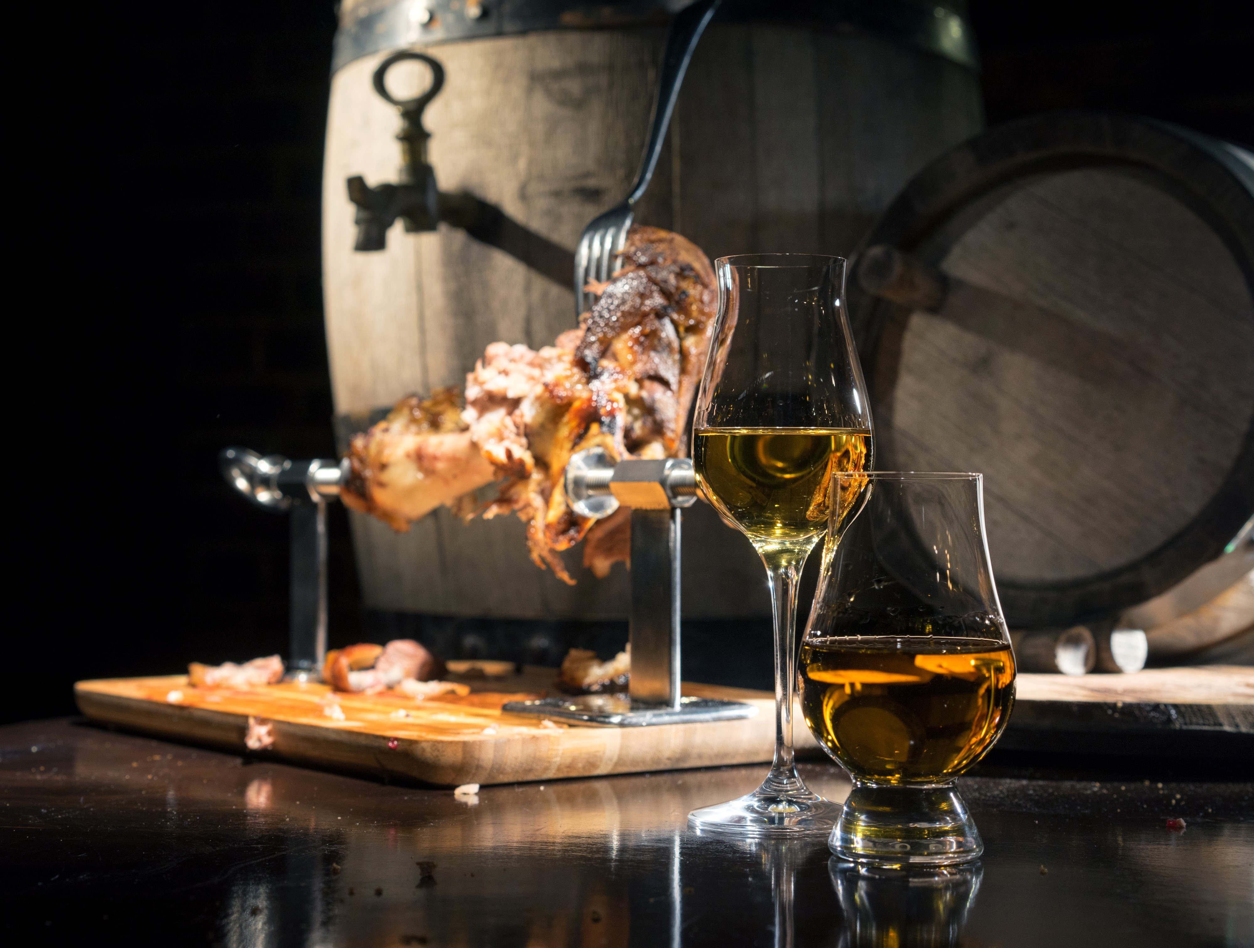 Meat on spit with whiskey and barrels HD Wallpaper