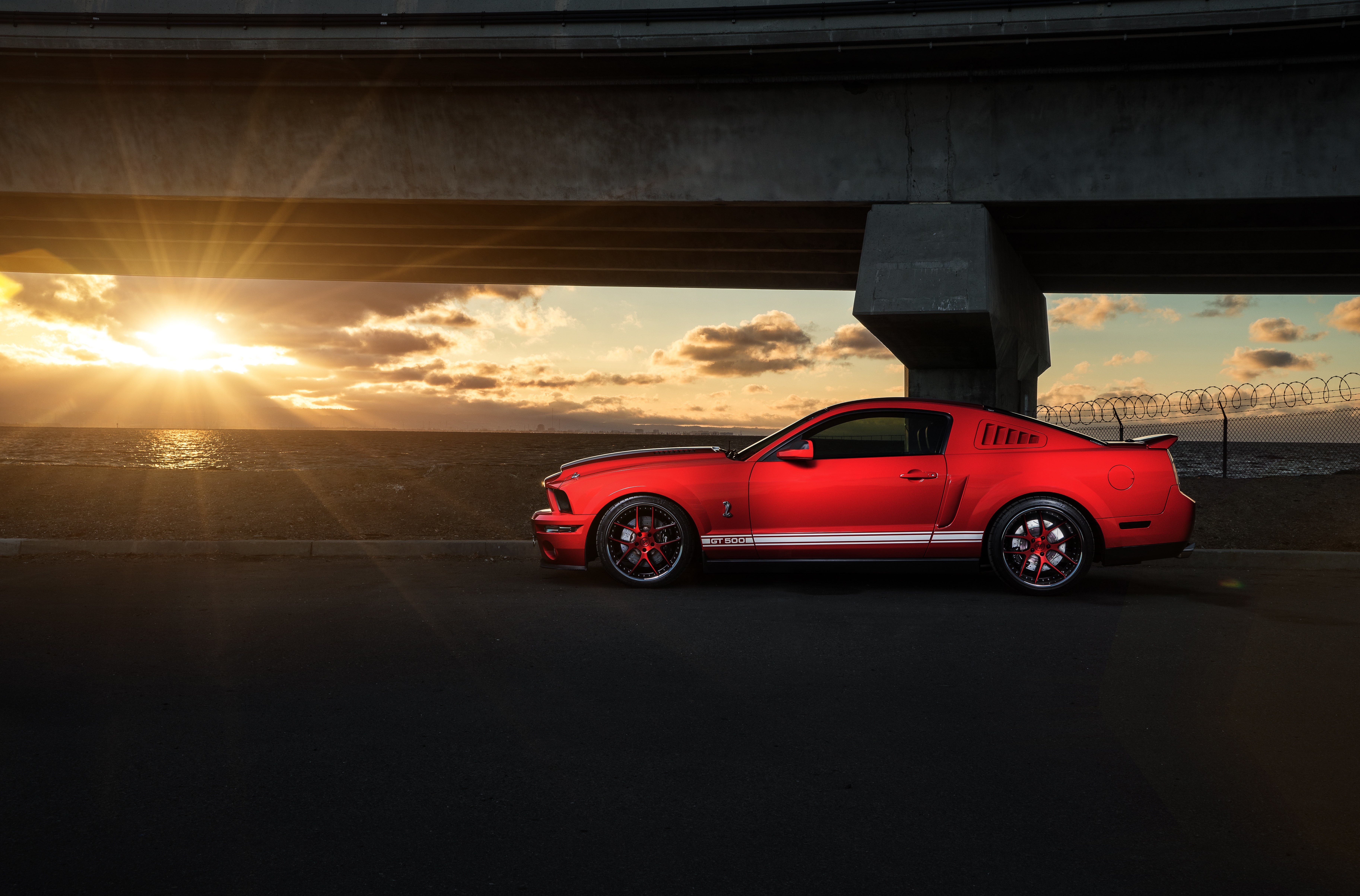 Red Ford Mustang Shelby GT500 by the ocean at sunset HD Wallpaper
