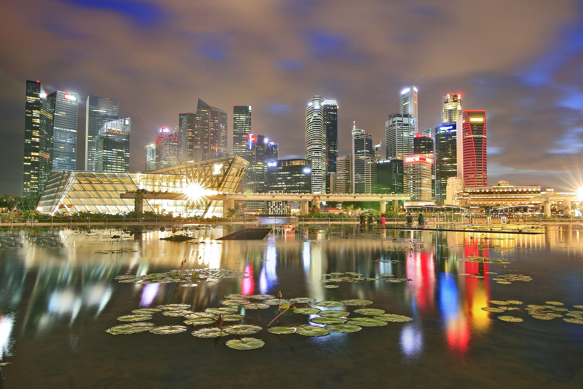 Singapore skyline at night with reflections in a pond HD Wallpaper