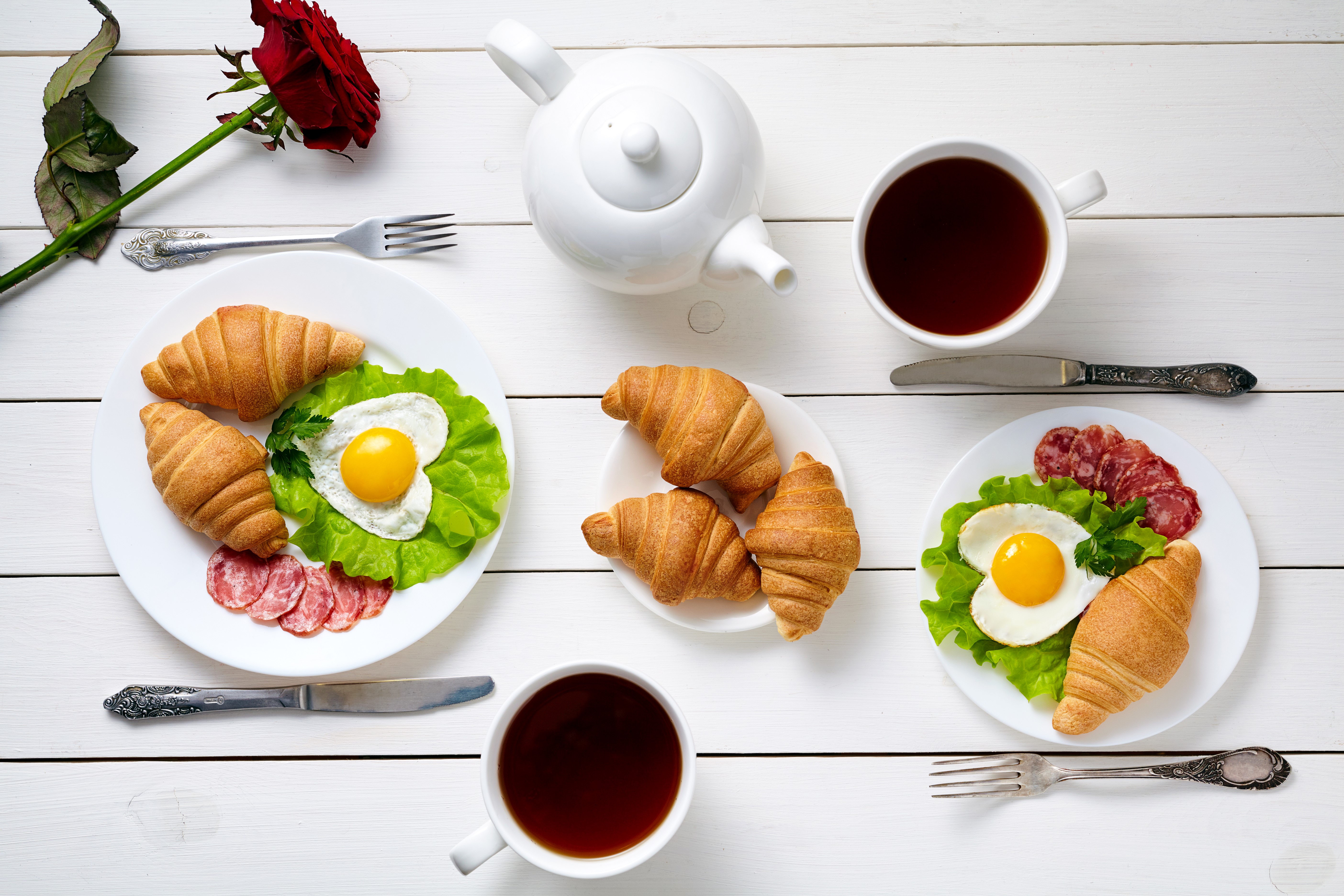 Breakfast with croissants, fried eggs, sausage, and tea HD Wallpaper