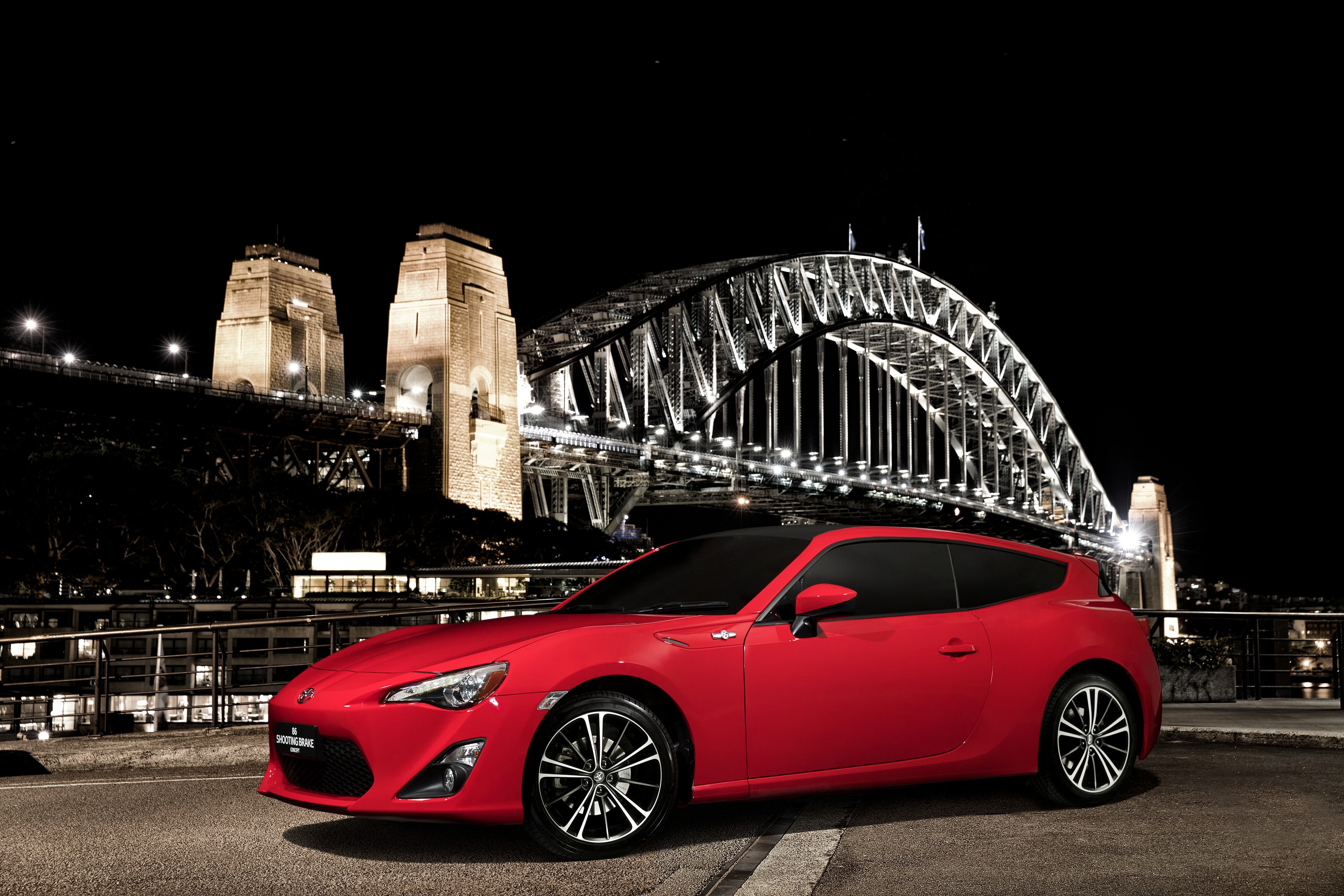 Red Toyota 86 Shooting Brake Concept car at night near Sydney Harbour Bridge HD Wallpaper