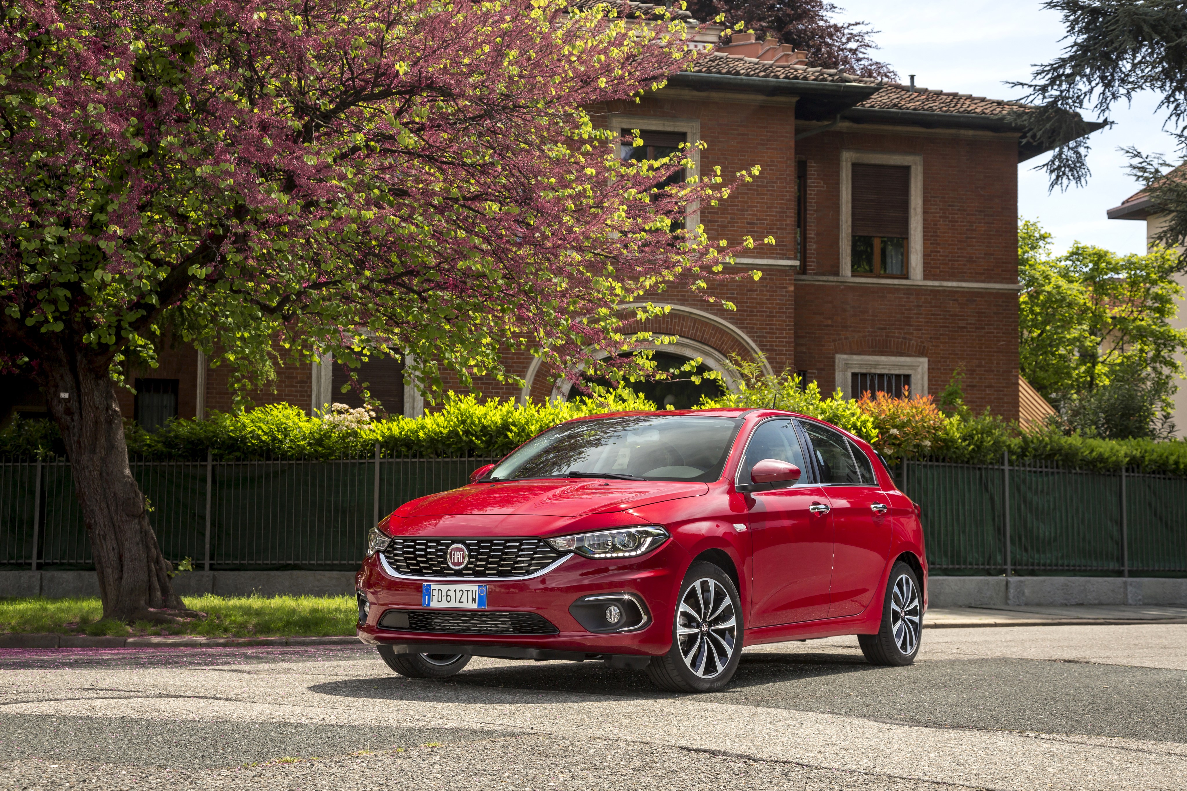 Red Fiat Tipo 5-door parked near a house HD Wallpaper