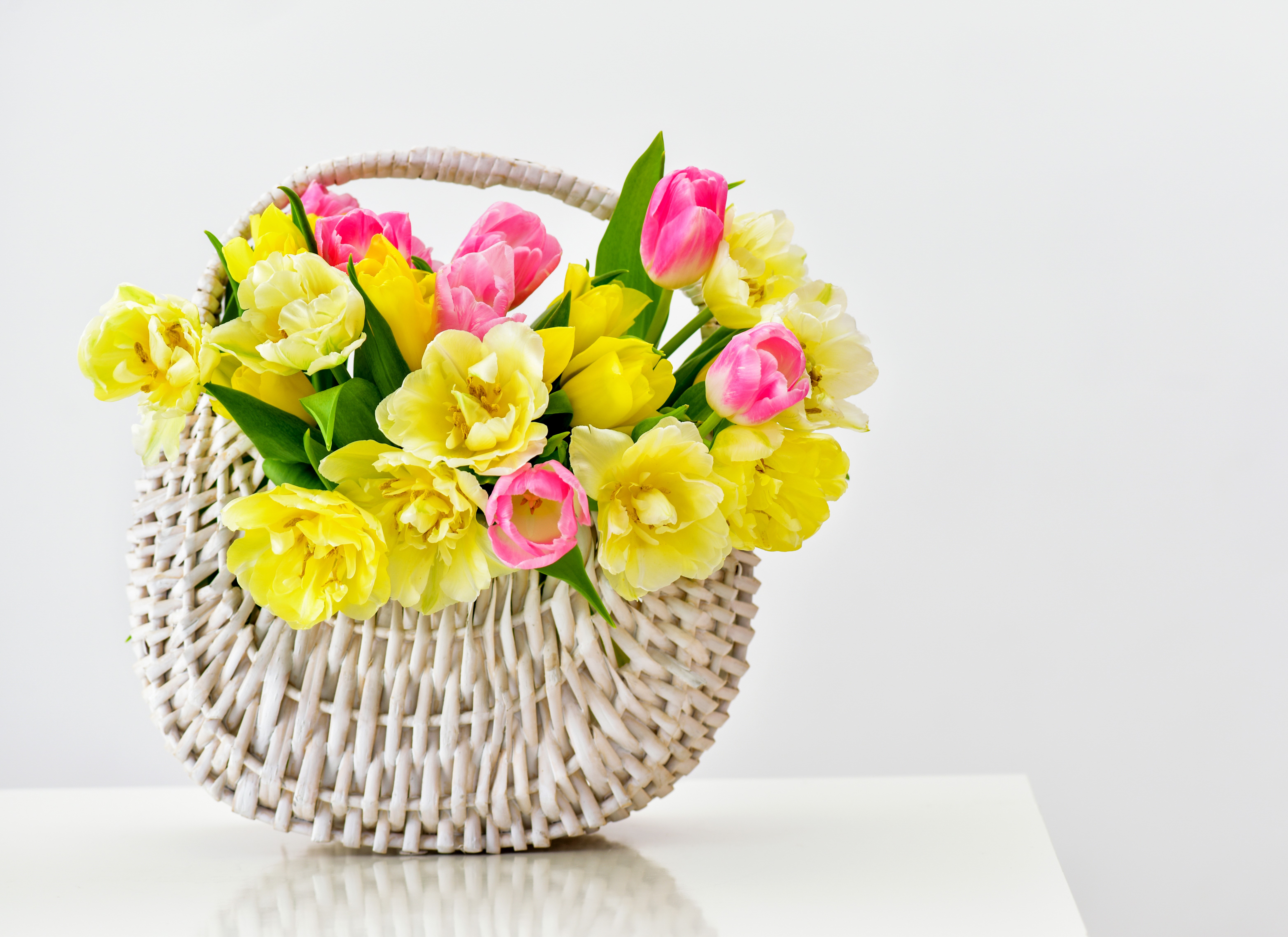 Yellow and pink tulips in a wicker basket HD Wallpaper