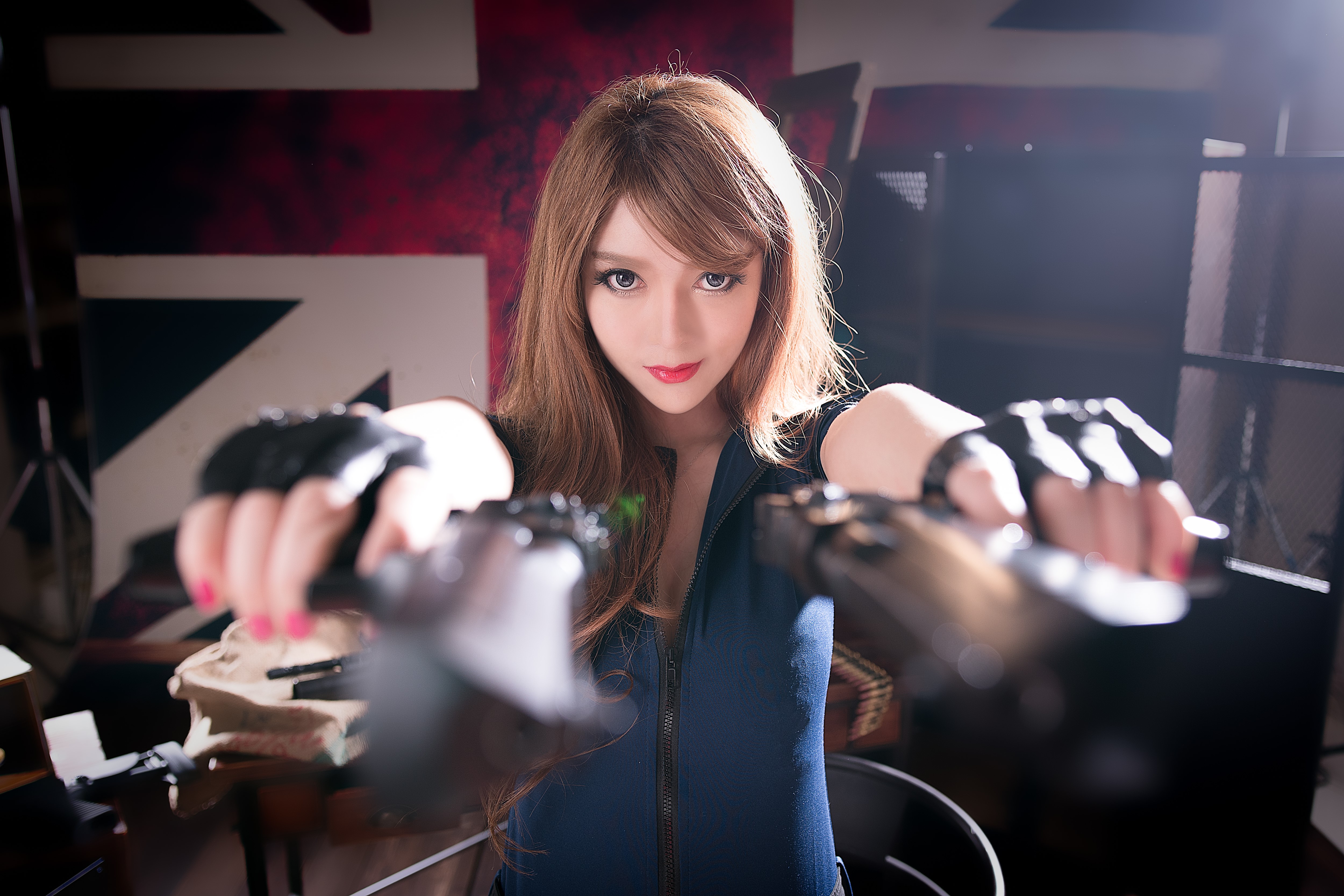 Asian woman with brown hair holding pistols HD Wallpaper