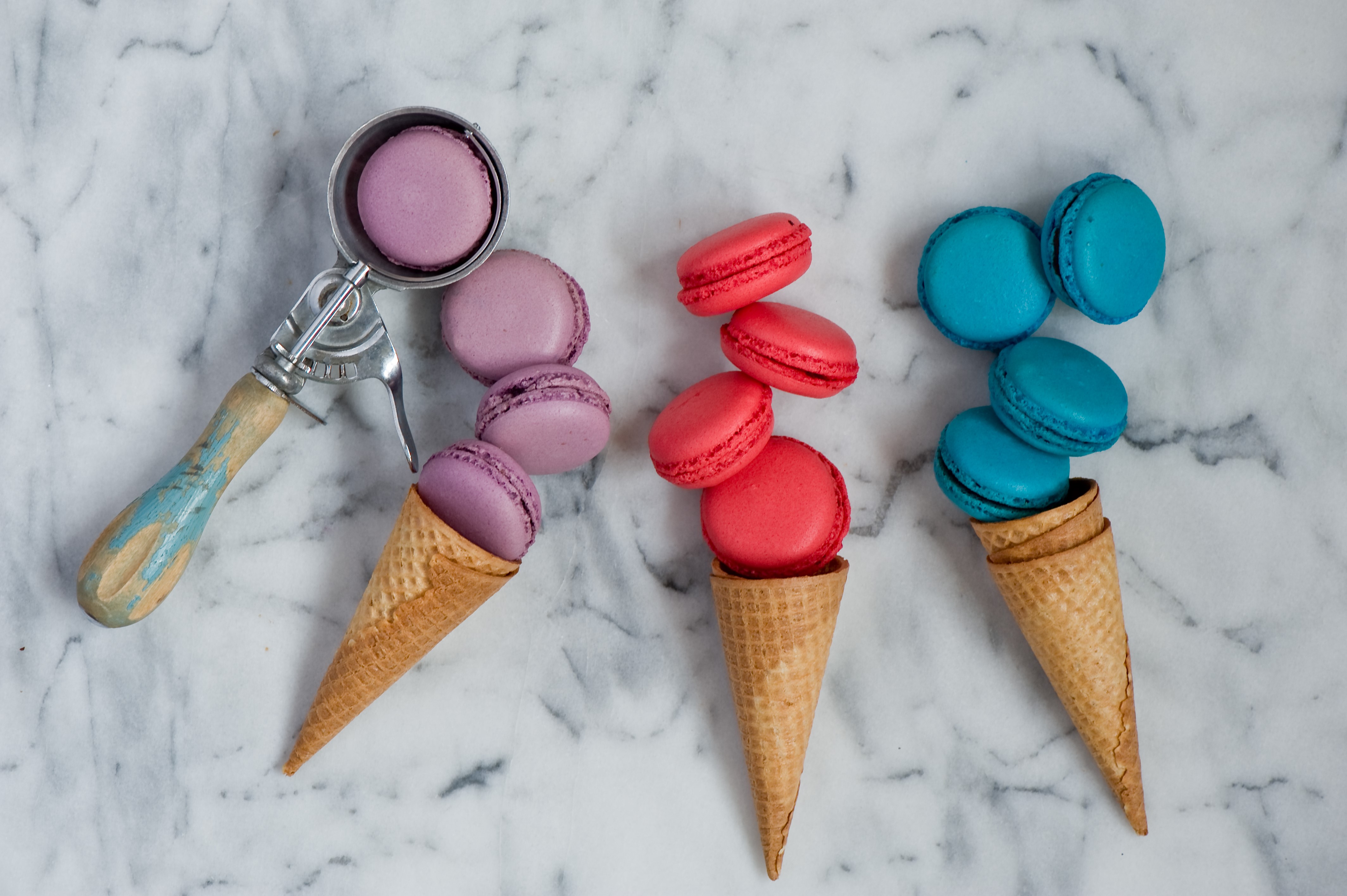 Purple, Red, and Blue Macarons in Cones with Ice Cream Scoop HD Wallpaper