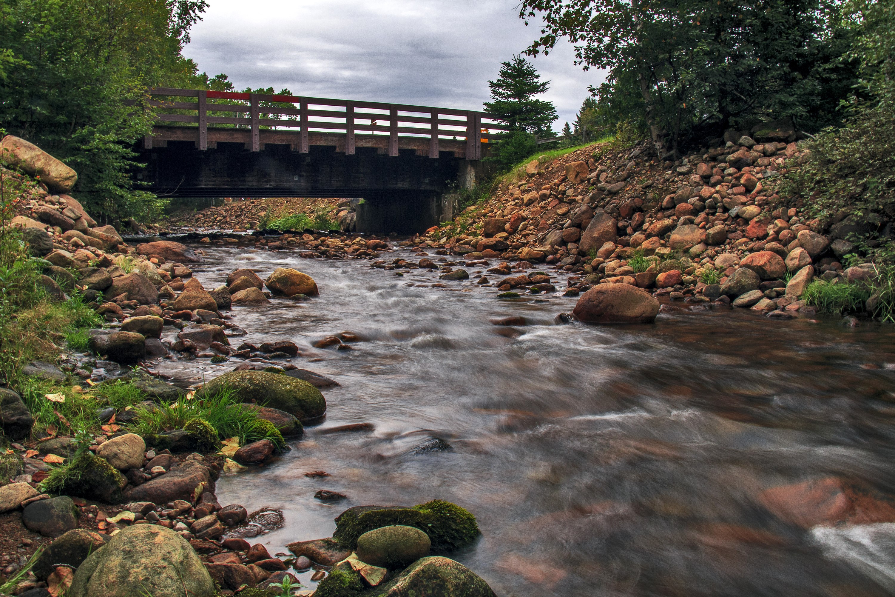 Wooden bridge over a rocky river in Quebec, Canada HD Wallpaper