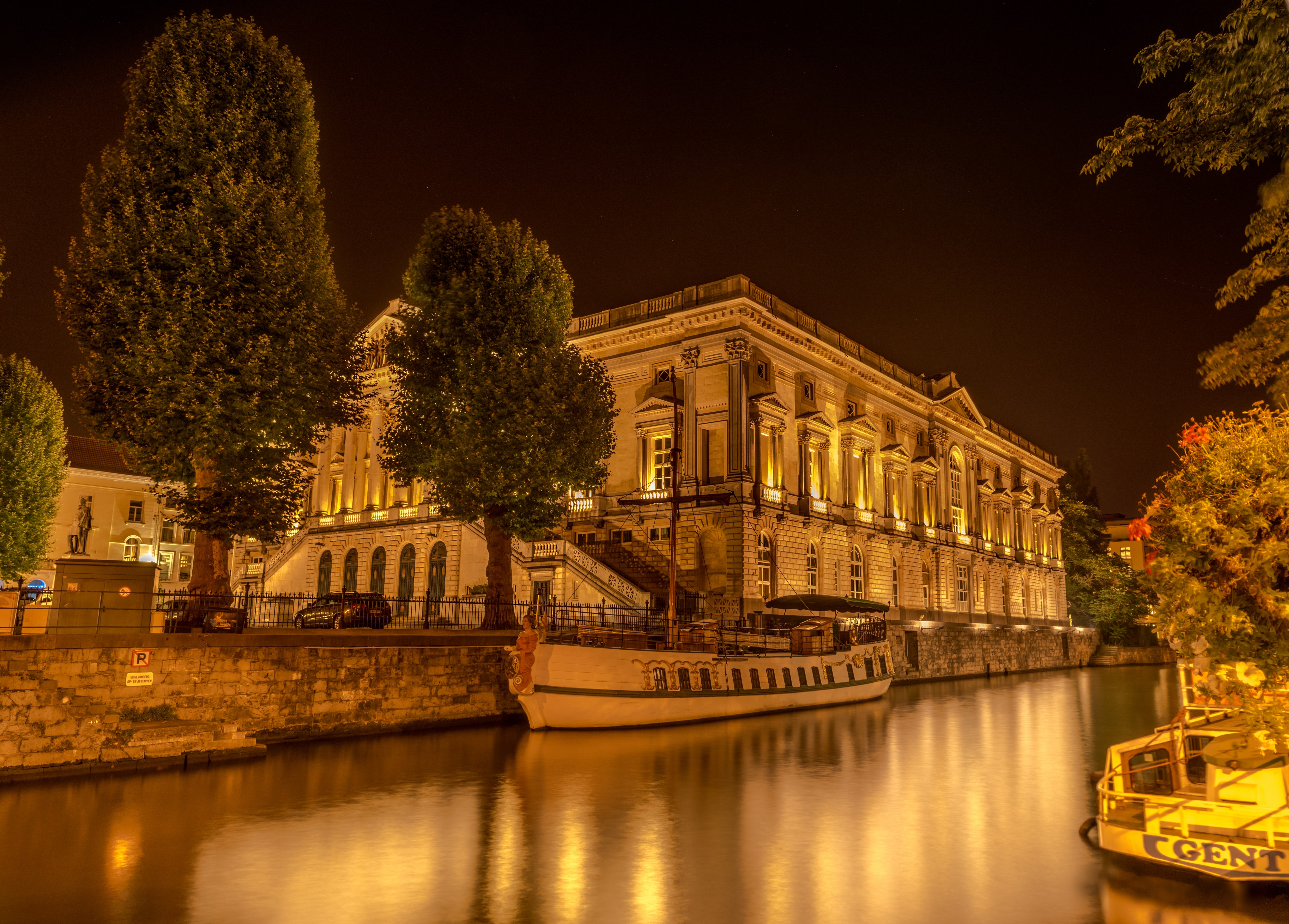 Building and boats on a canal at night HD Wallpaper