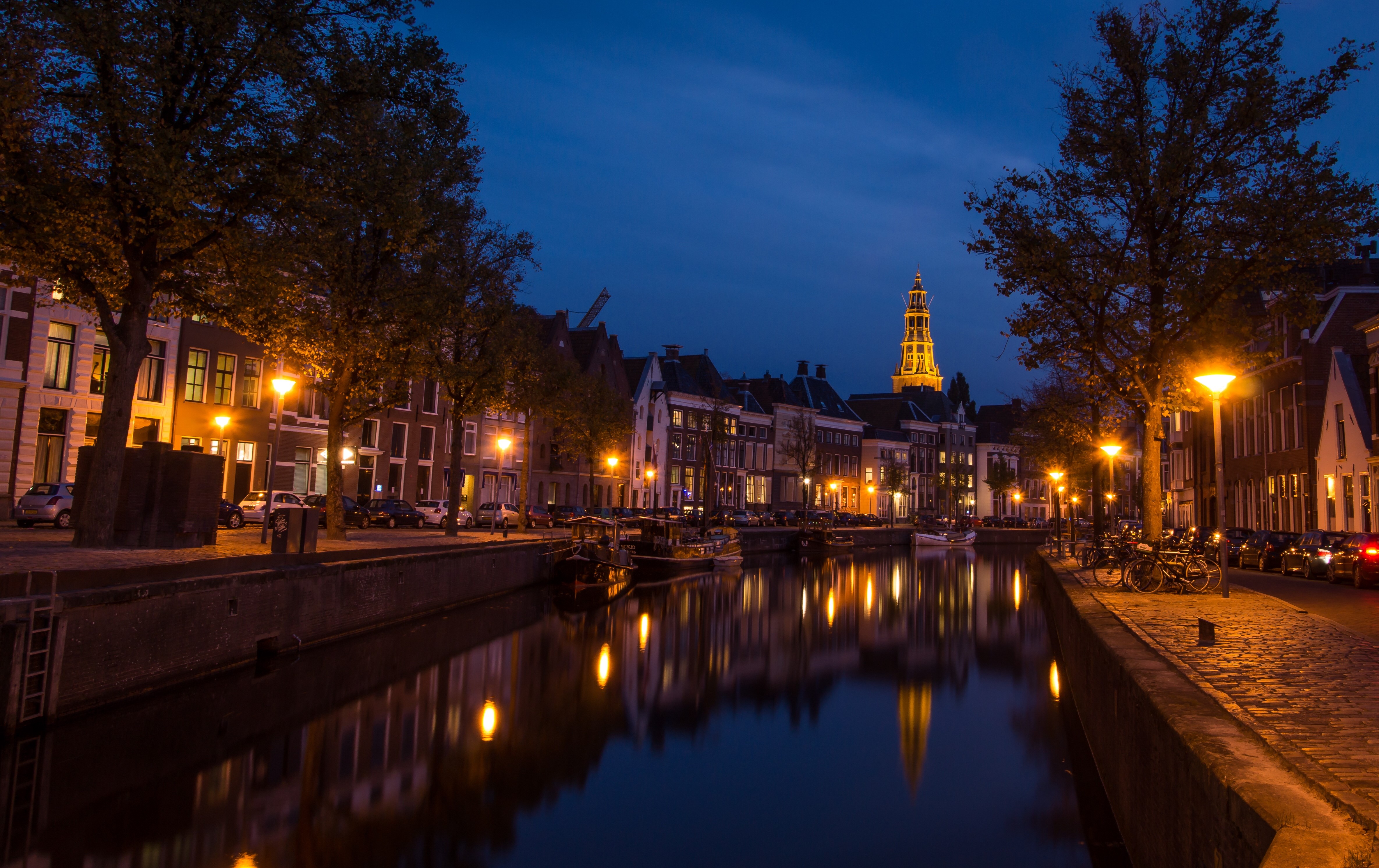 Groningen canal at night with illuminated buildings and tower HD Wallpaper