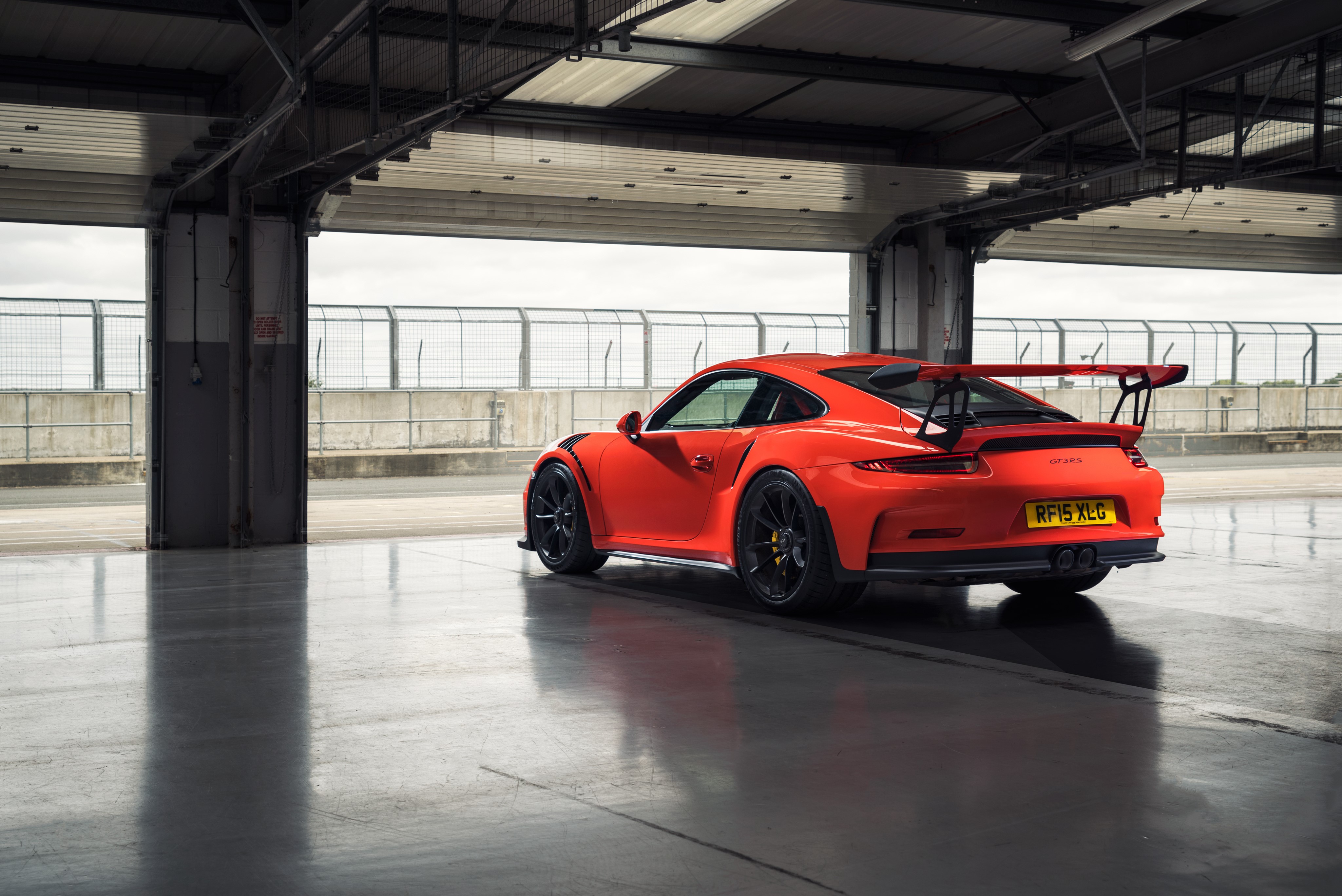 Orange Porsche 911 GT3 in a garage HD Wallpaper