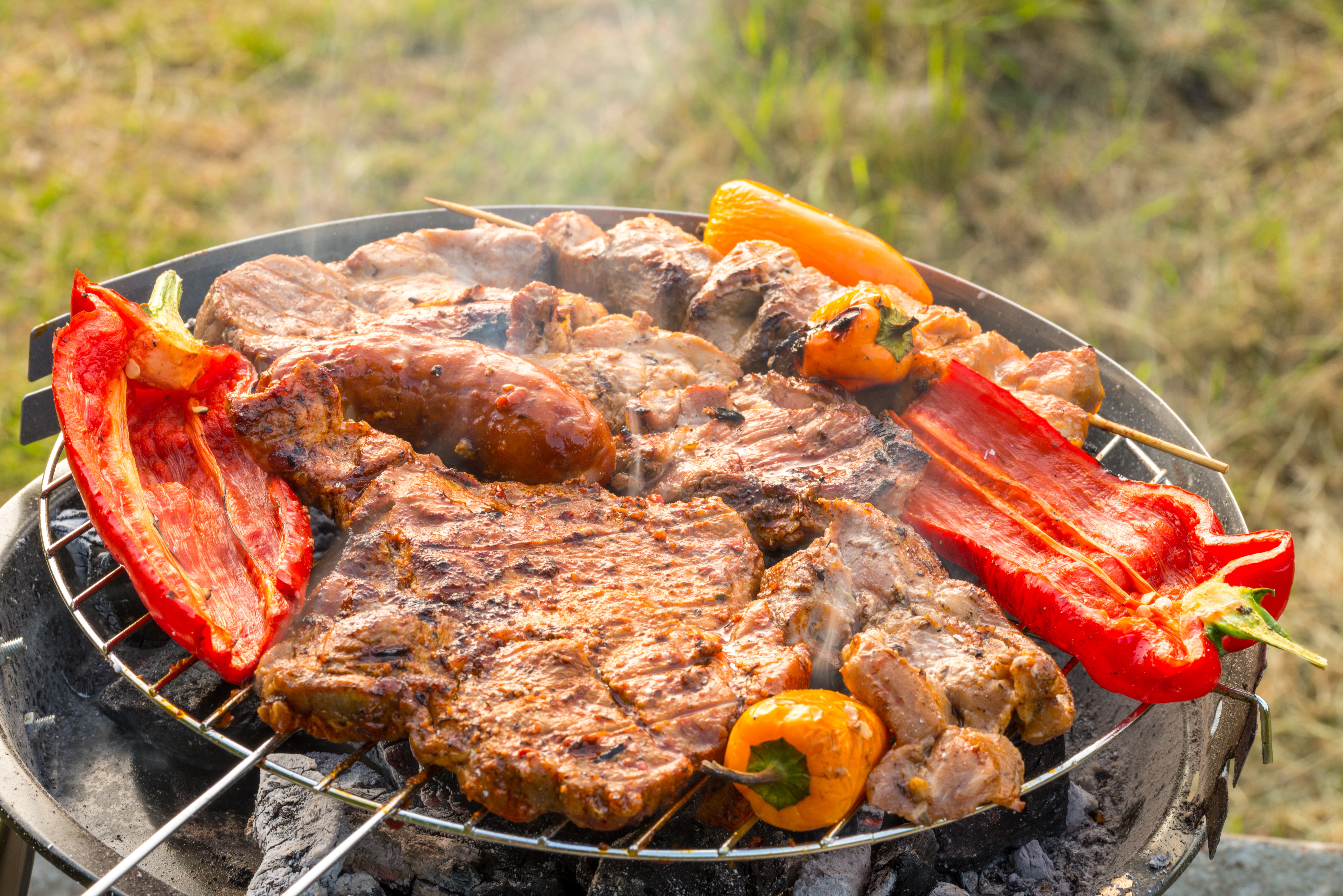 Meat products and bell peppers on a grill HD Wallpaper