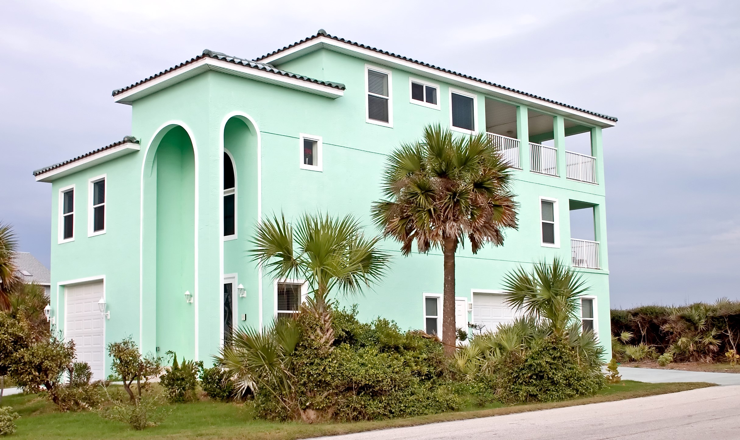 A mint green mansion with palm trees HD Wallpaper