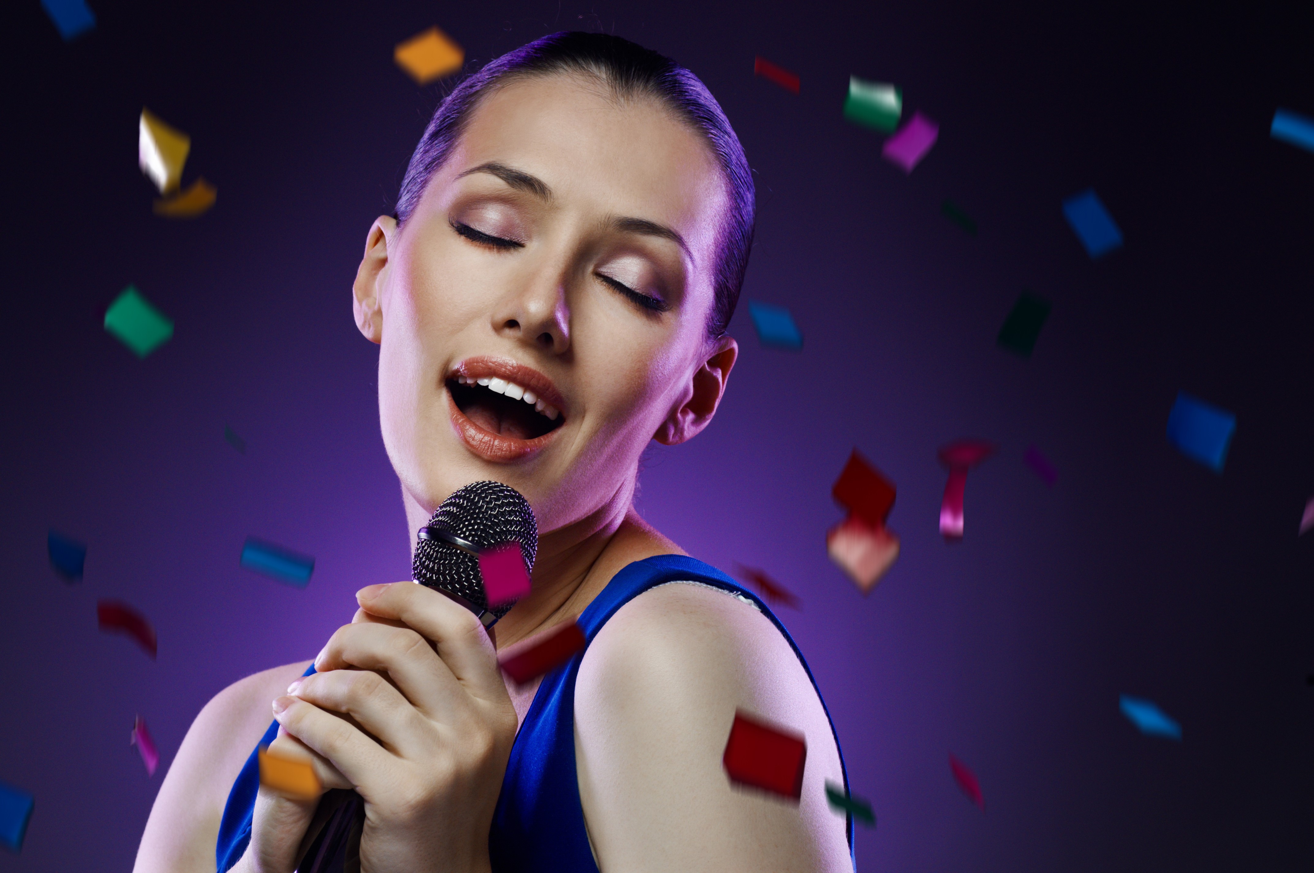 Woman singing into a microphone with confetti HD Wallpaper