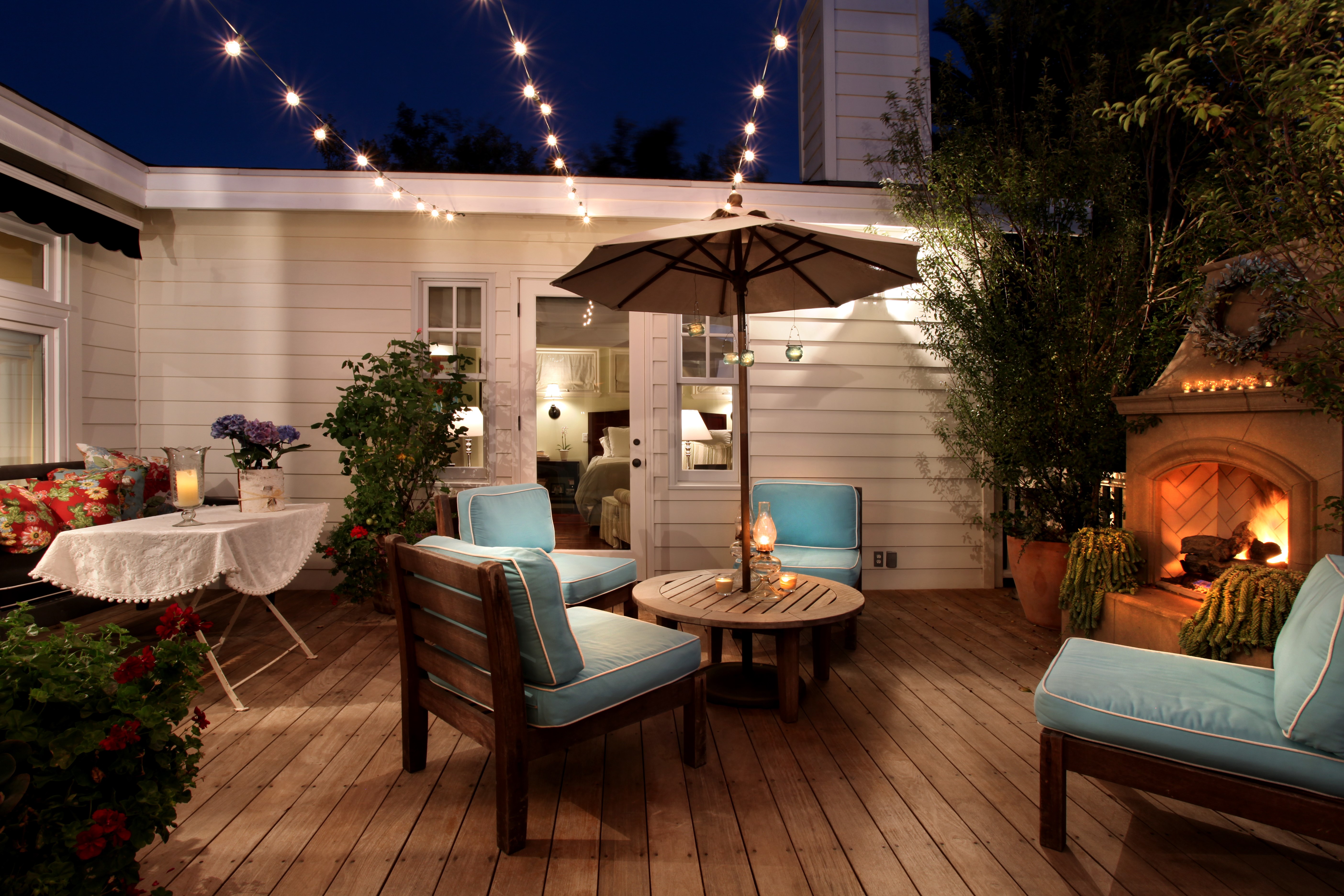 Outdoor Patio with Fireplace and String Lights HD Wallpaper
