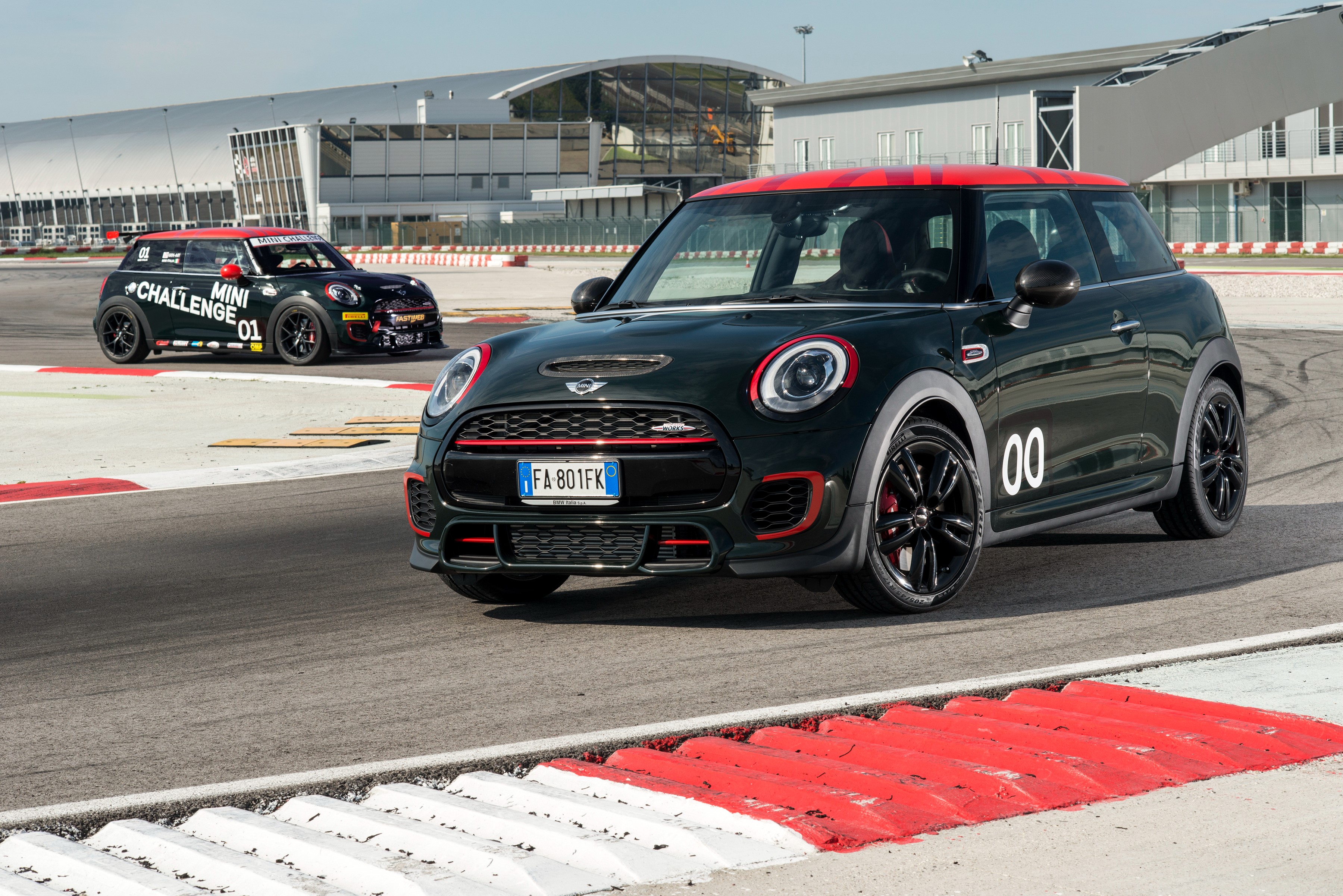 Two Mini Cooper Challenge cars on a race track HD Wallpaper