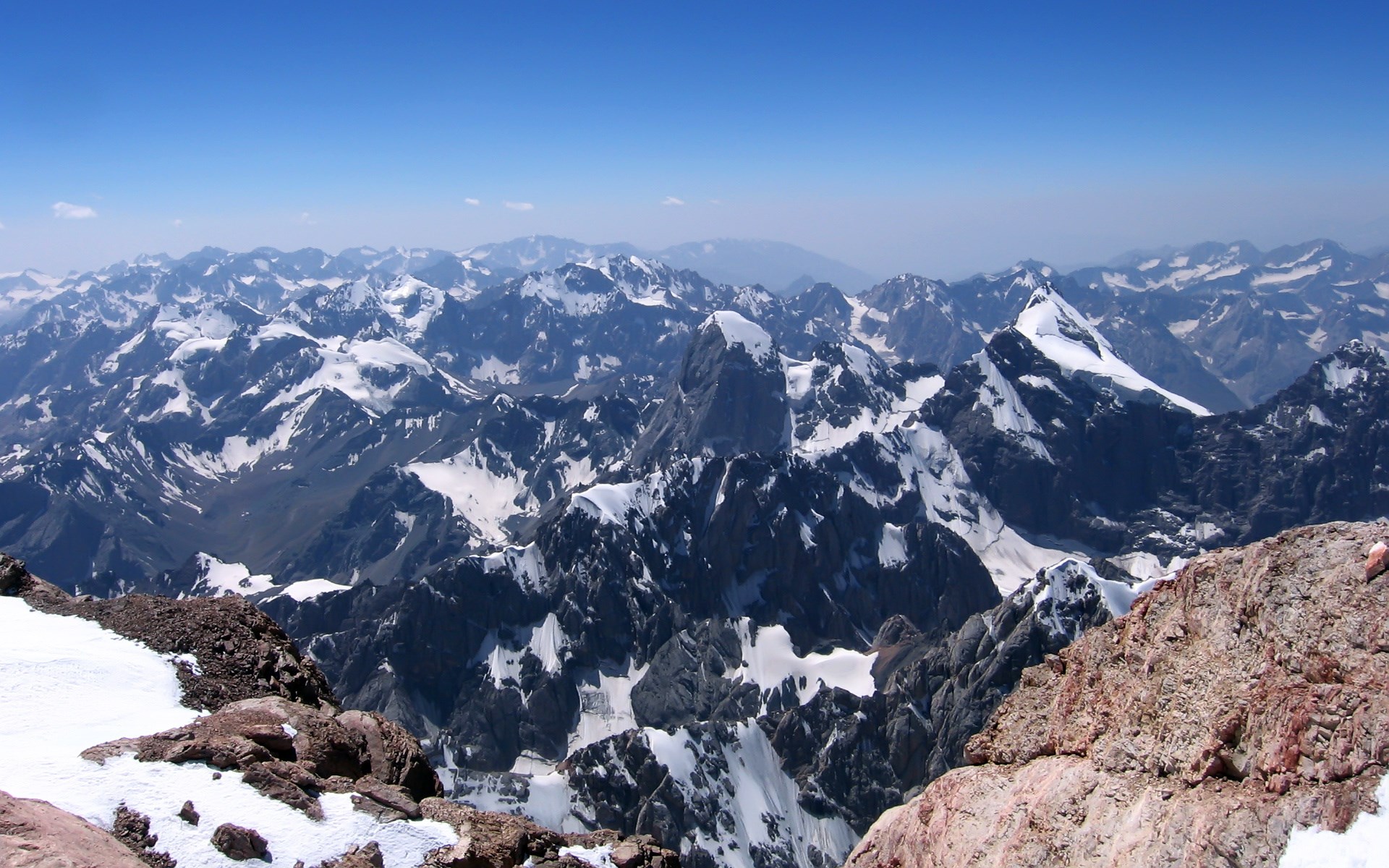 Snow-capped mountains under a clear blue sky HD Wallpaper