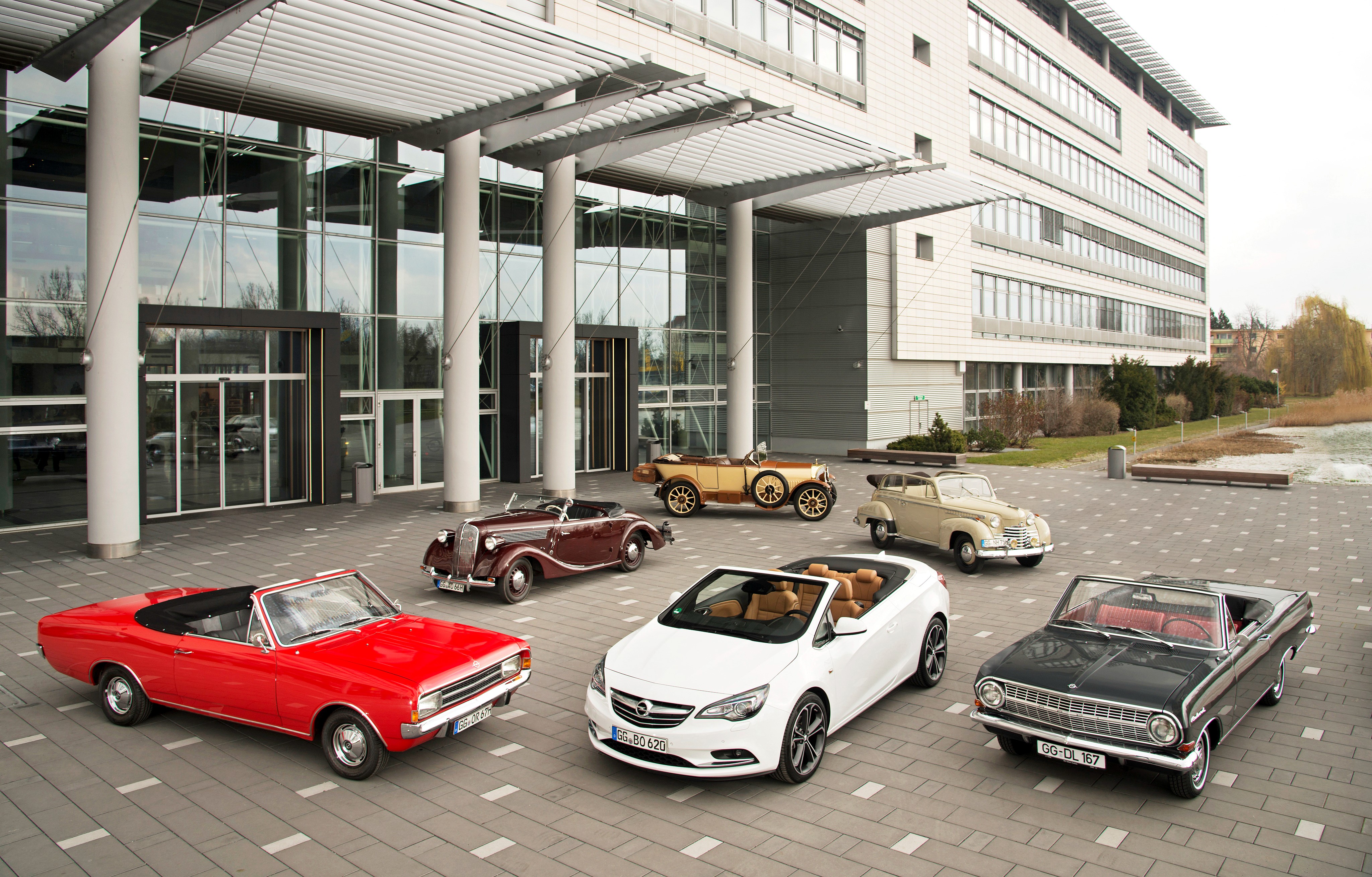 Opel Retro Cabriolets in front of a modern building HD Wallpaper