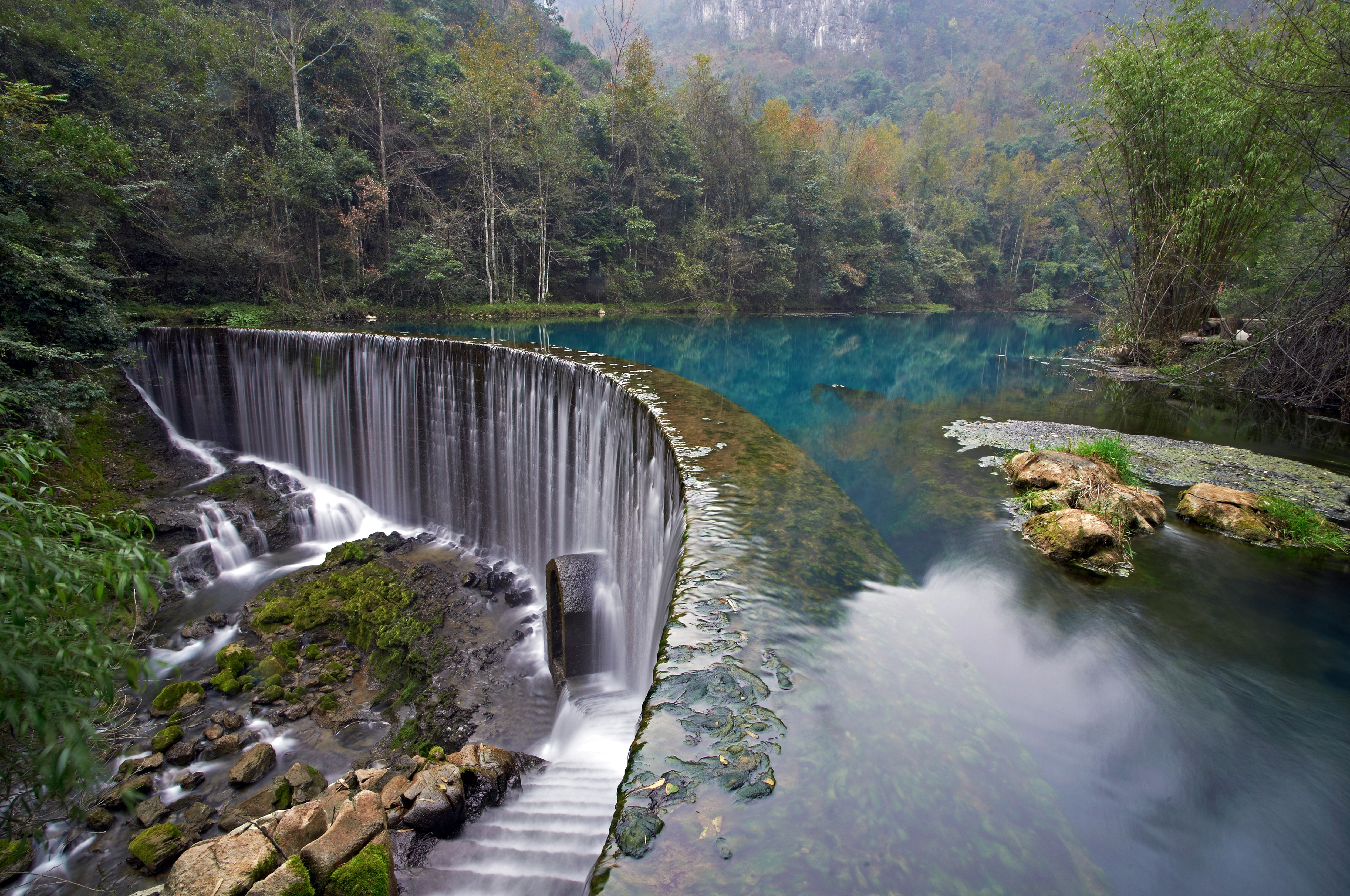 Waterfall and turquoise lake in a forest HD Wallpaper