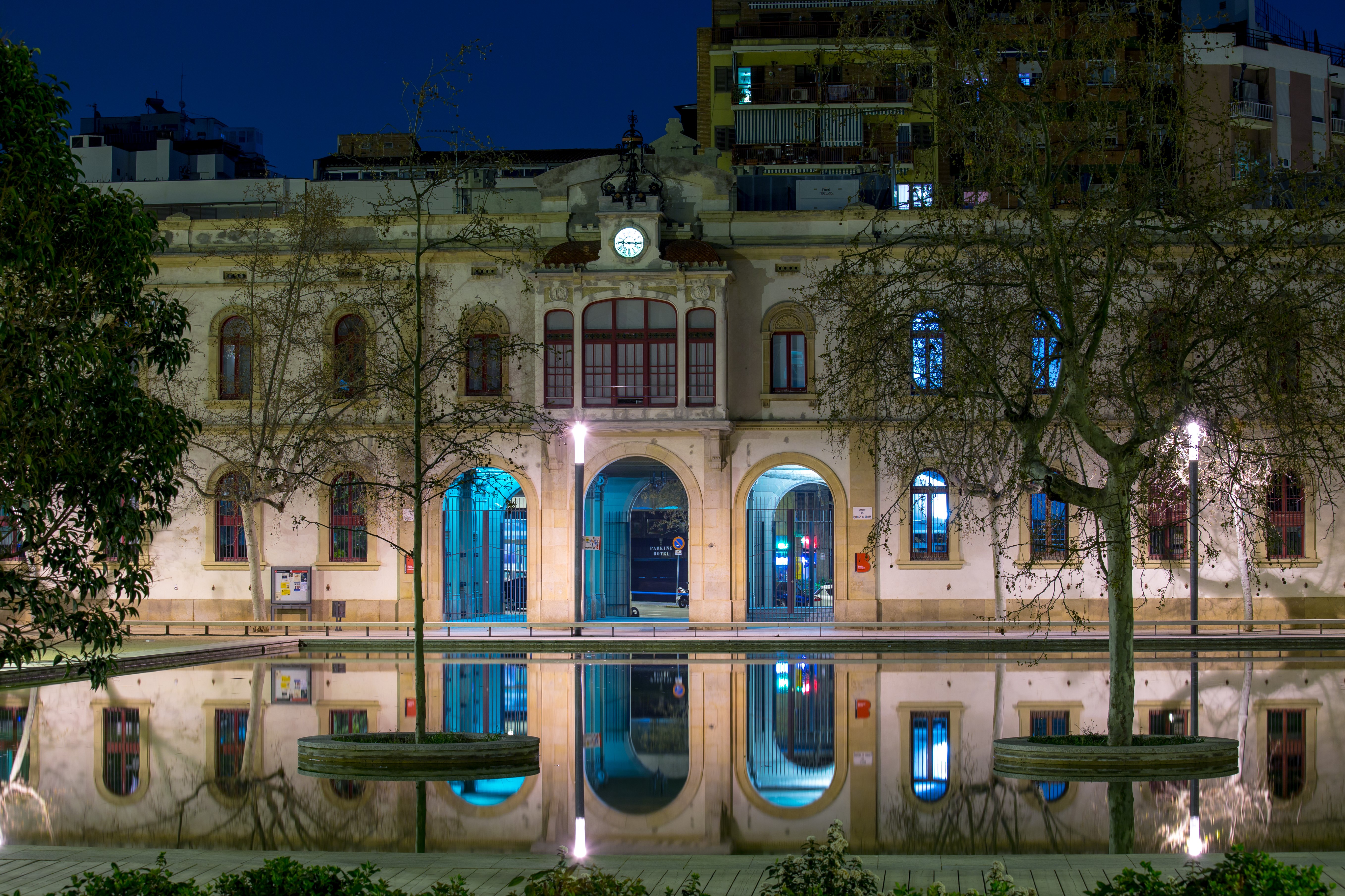 Building with arches and reflection in water at night HD Wallpaper