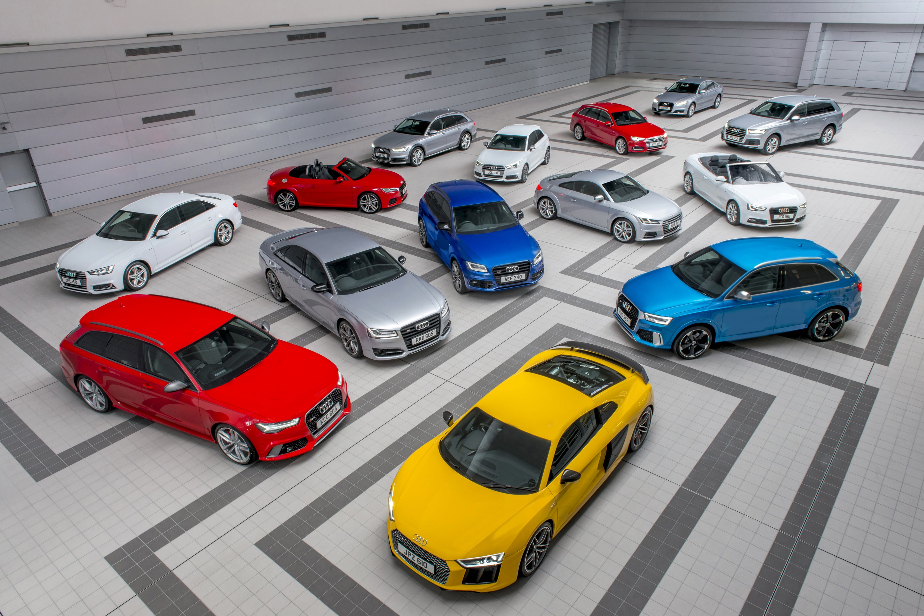 Many Audi cars parked in a showroom HD Wallpaper