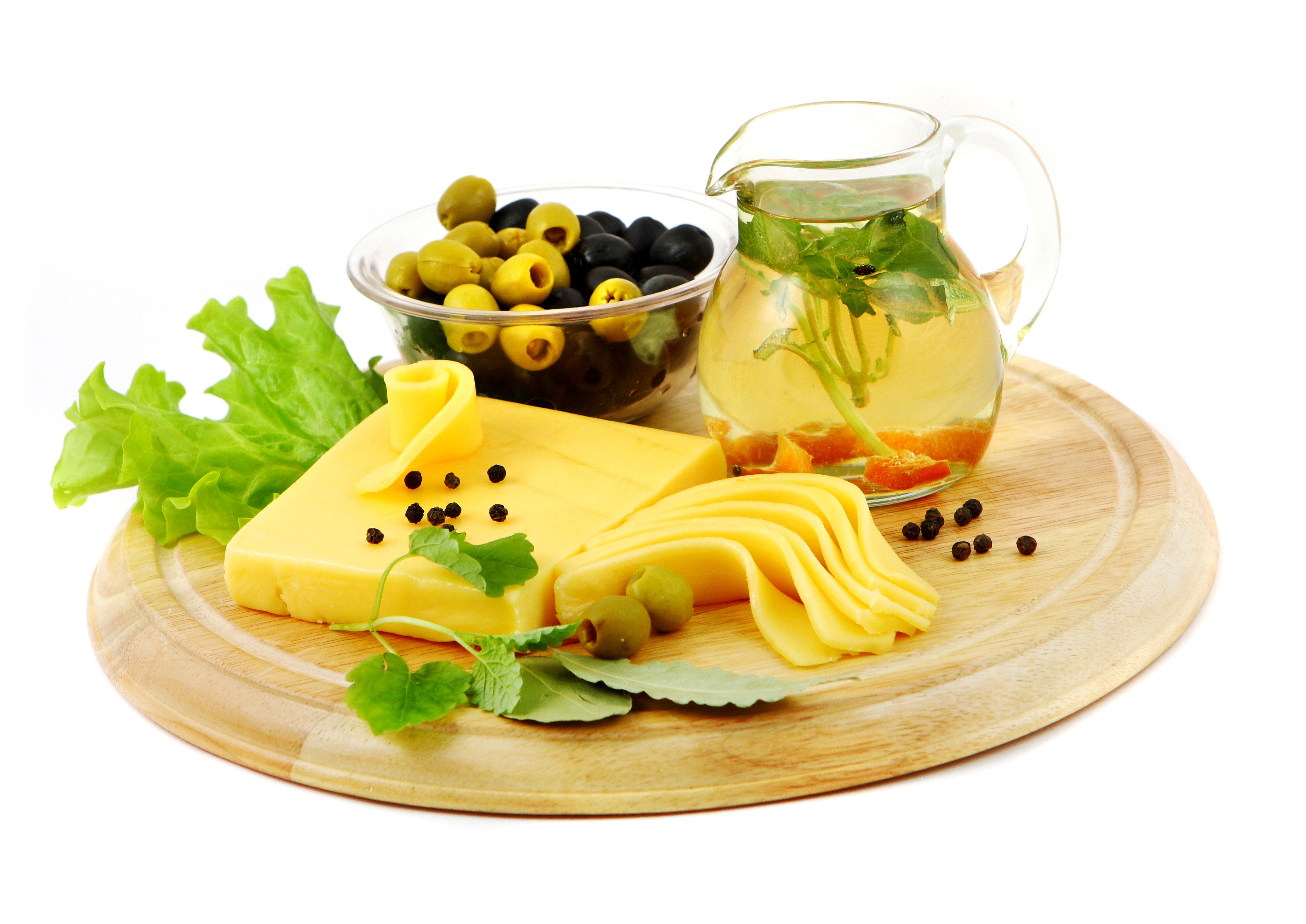 Cheese with olives and a jug of liquid on a wooden board HD Wallpaper