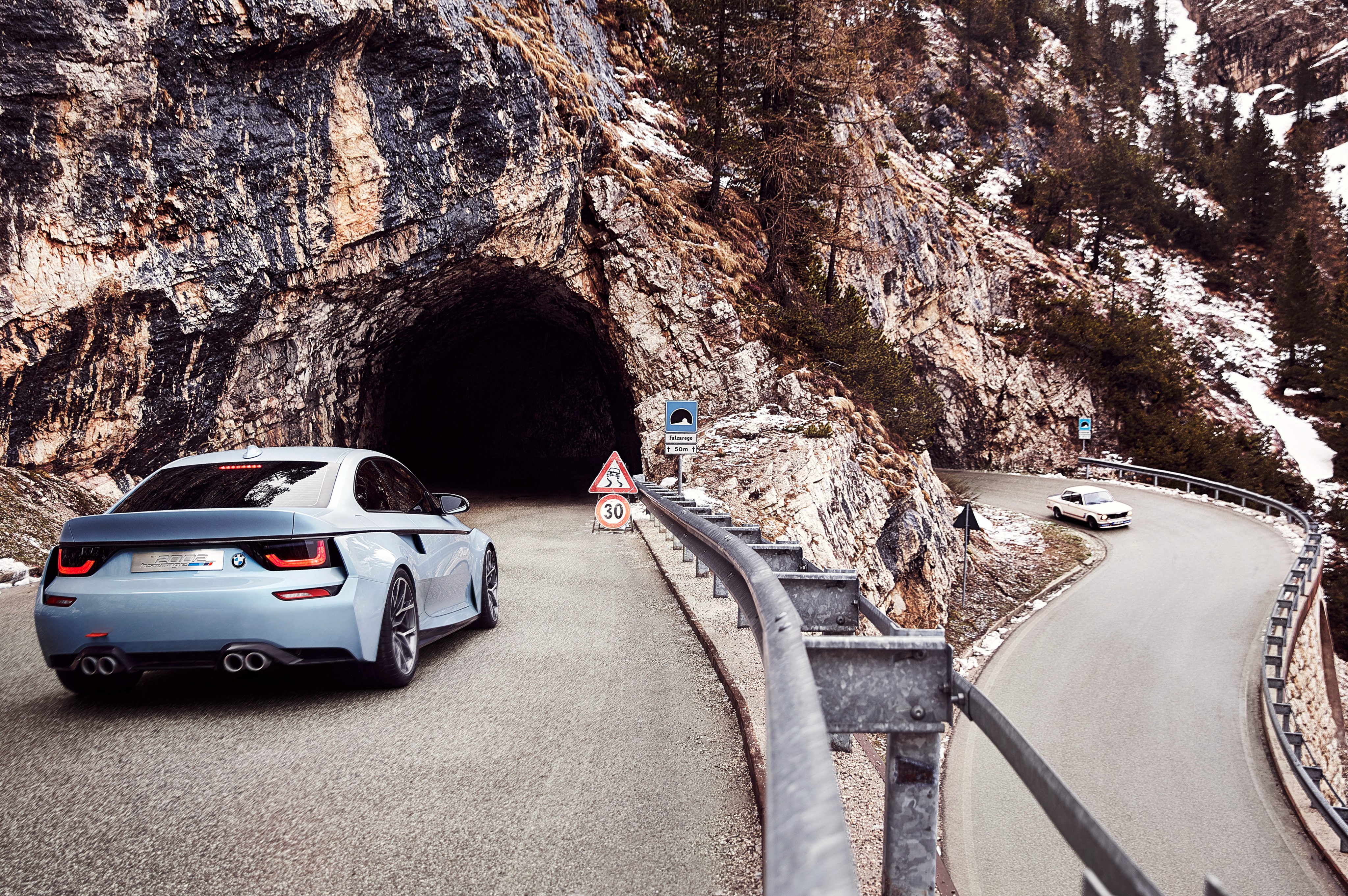 BMW car driving on a mountain road near a tunnel HD Wallpaper