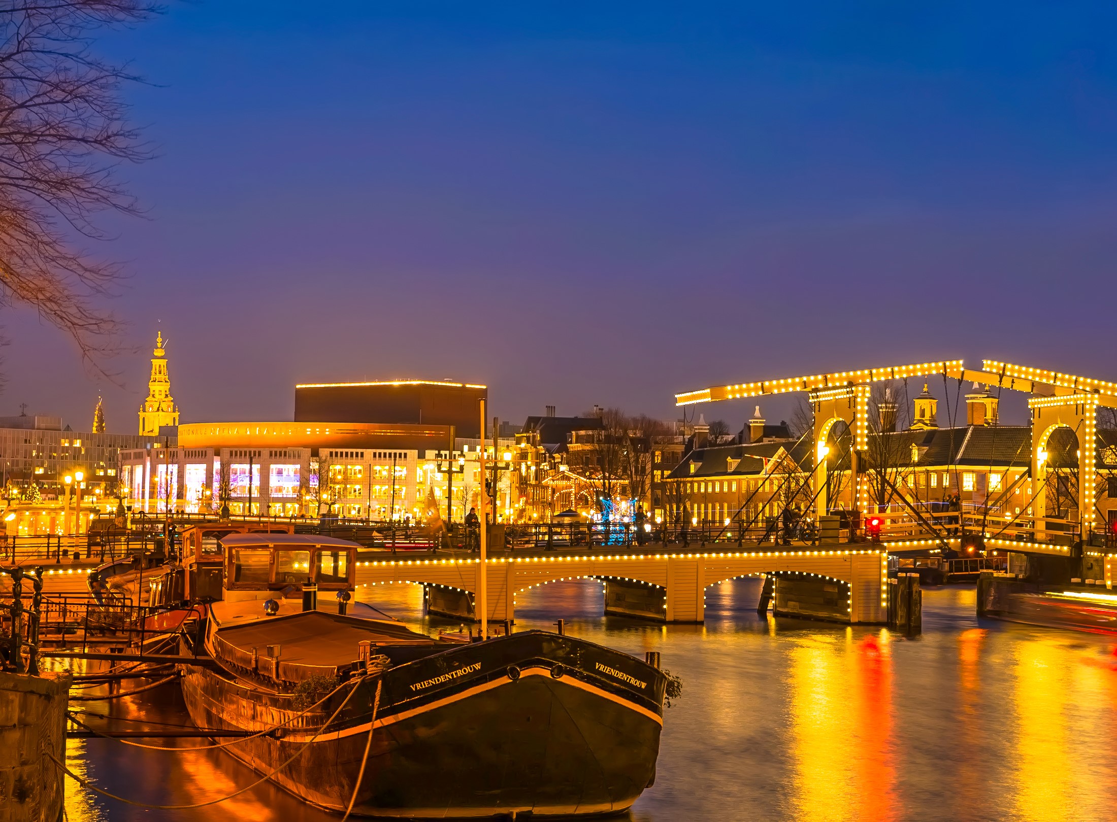 Amsterdam canal at night with illuminated bridges and buildings HD Wallpaper