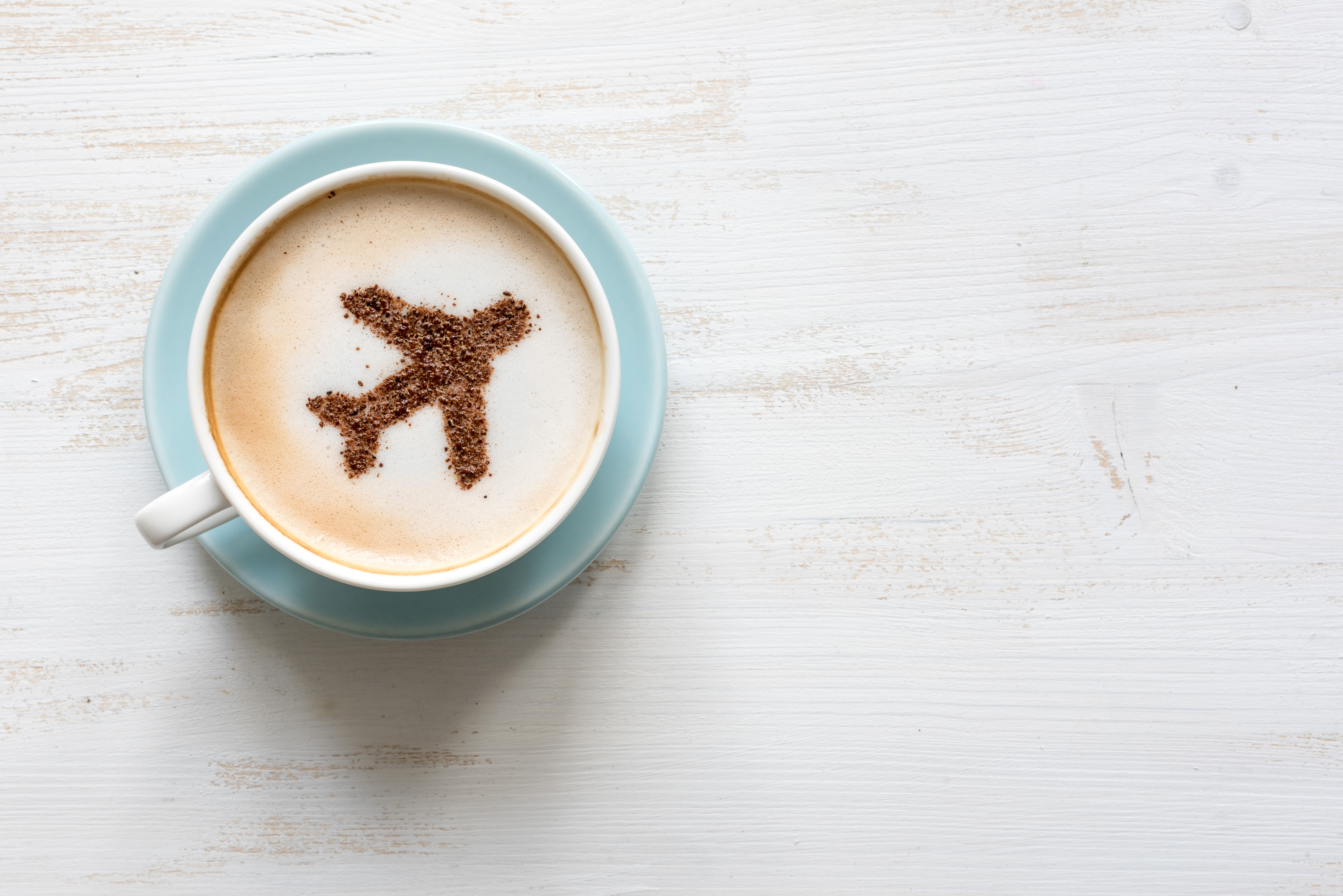 Coffee cup with airplane made of cocoa powder HD Wallpaper