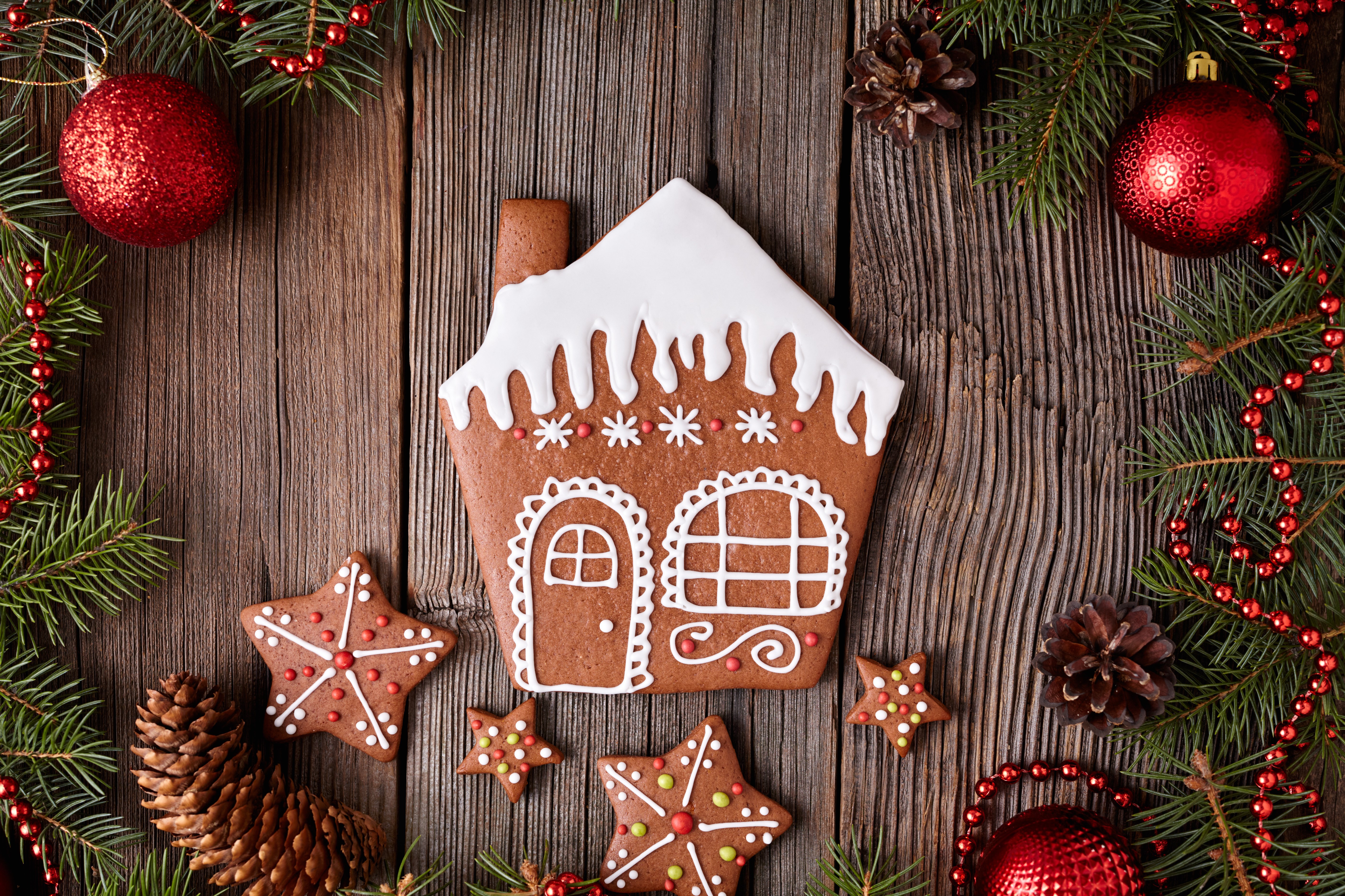 Christmas gingerbread house and cookies on wooden background HD Wallpaper