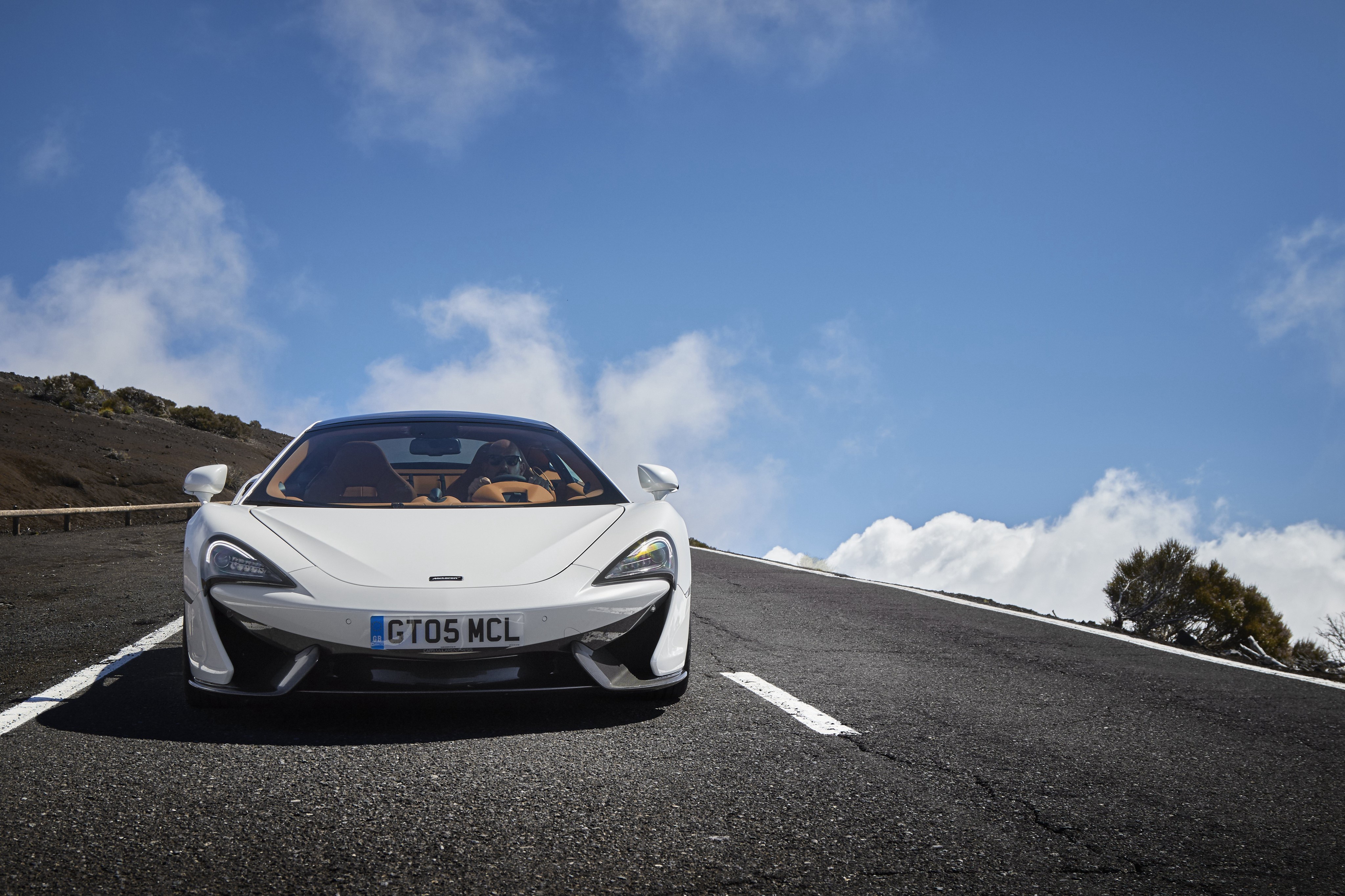 White McLaren 570GT on a Mountain Road HD Wallpaper