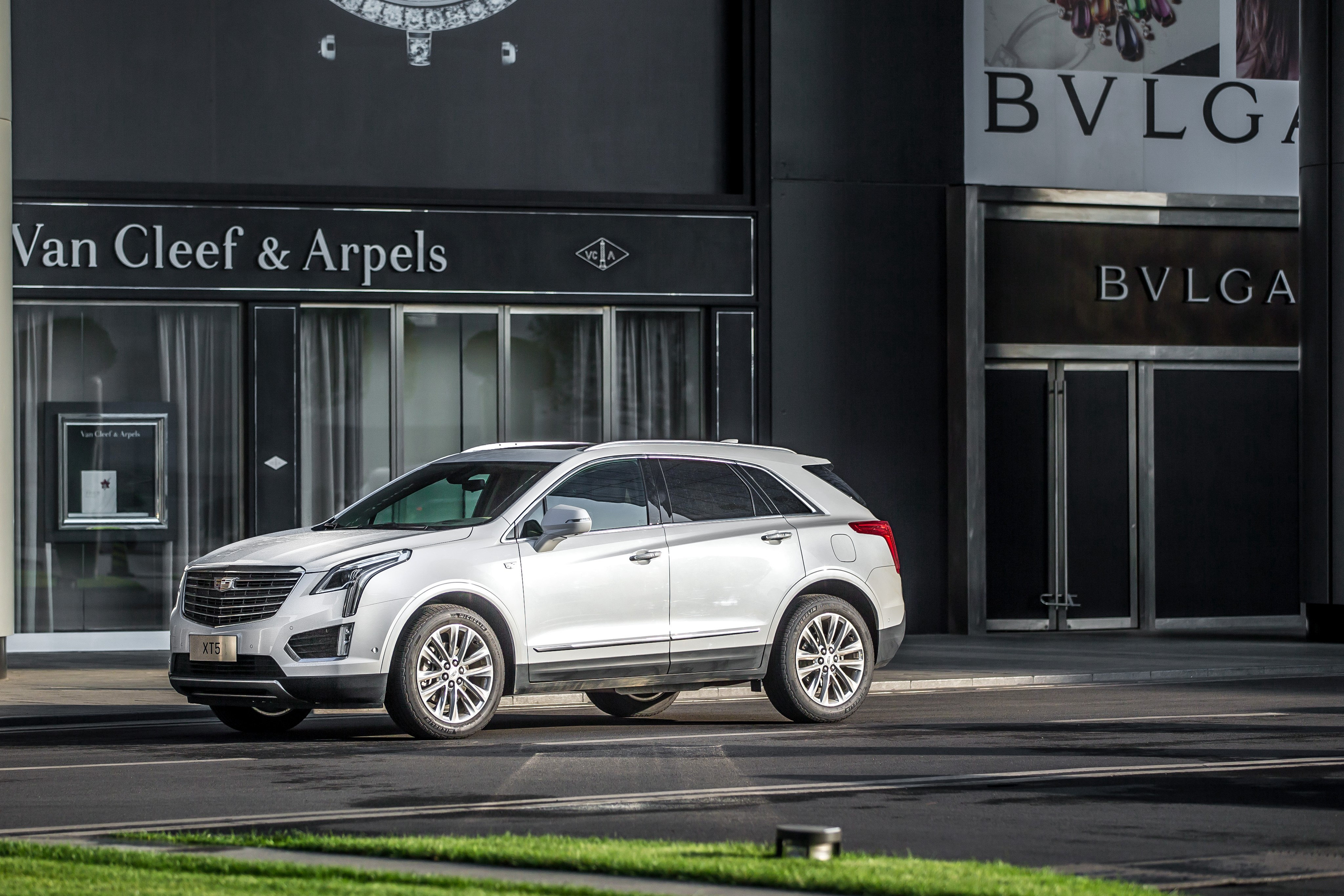 White 2016 Cadillac XT5 in front of Van Cleef & Arpels and Bvlgari HD Wallpaper