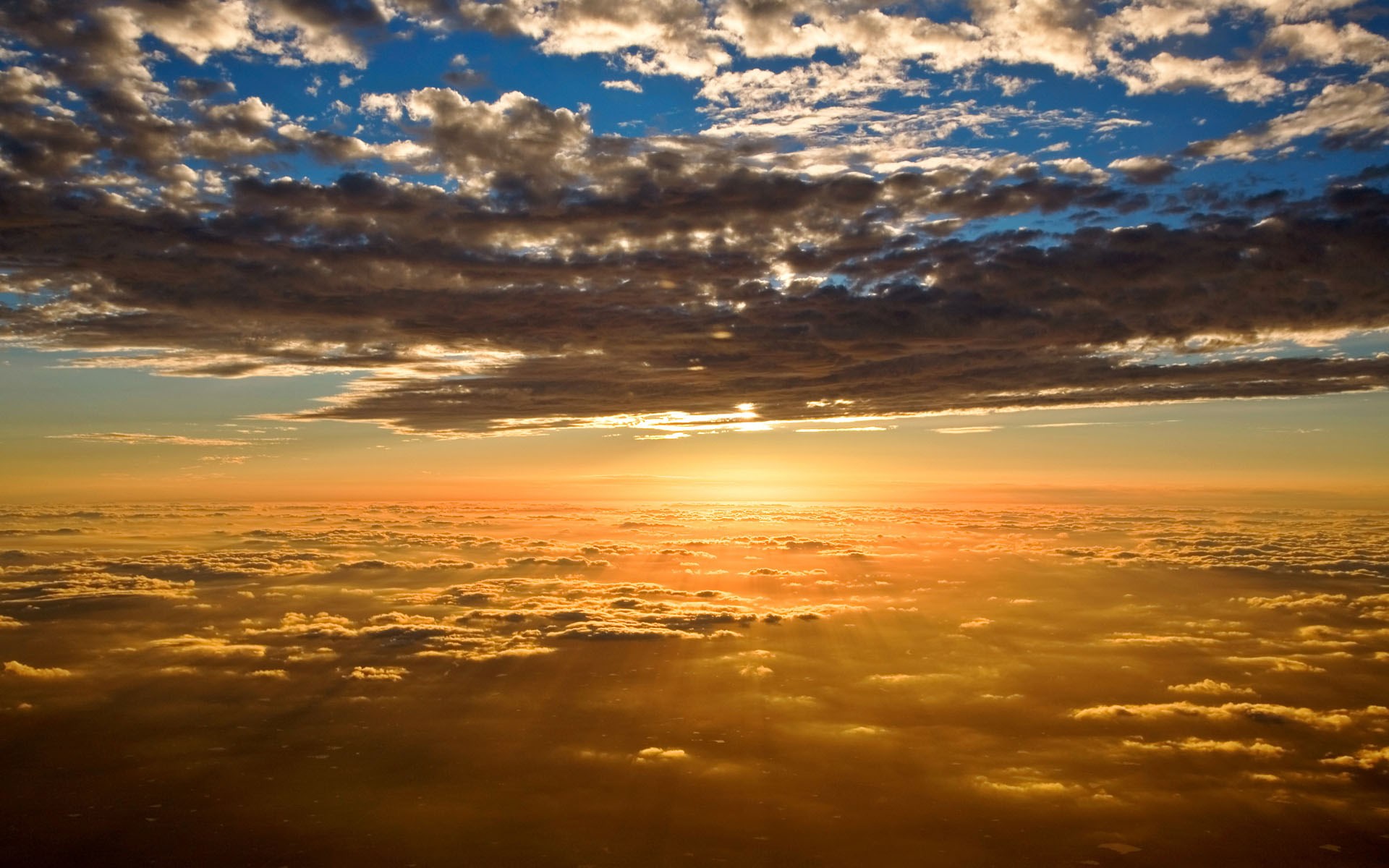 Sunset over clouds from airplane window HD Wallpaper