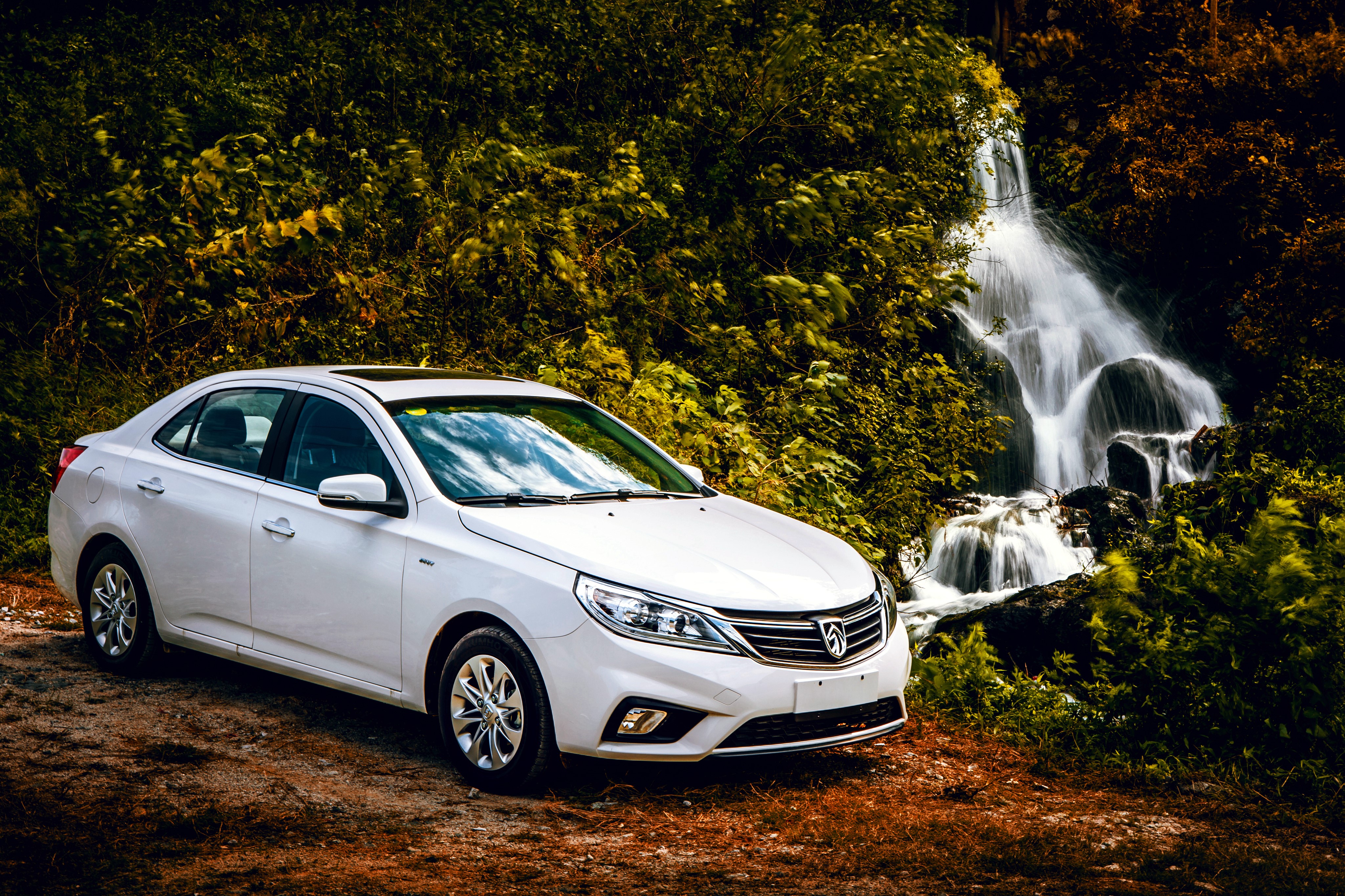 White Baojun 630 sedan parked near a waterfall HD Wallpaper