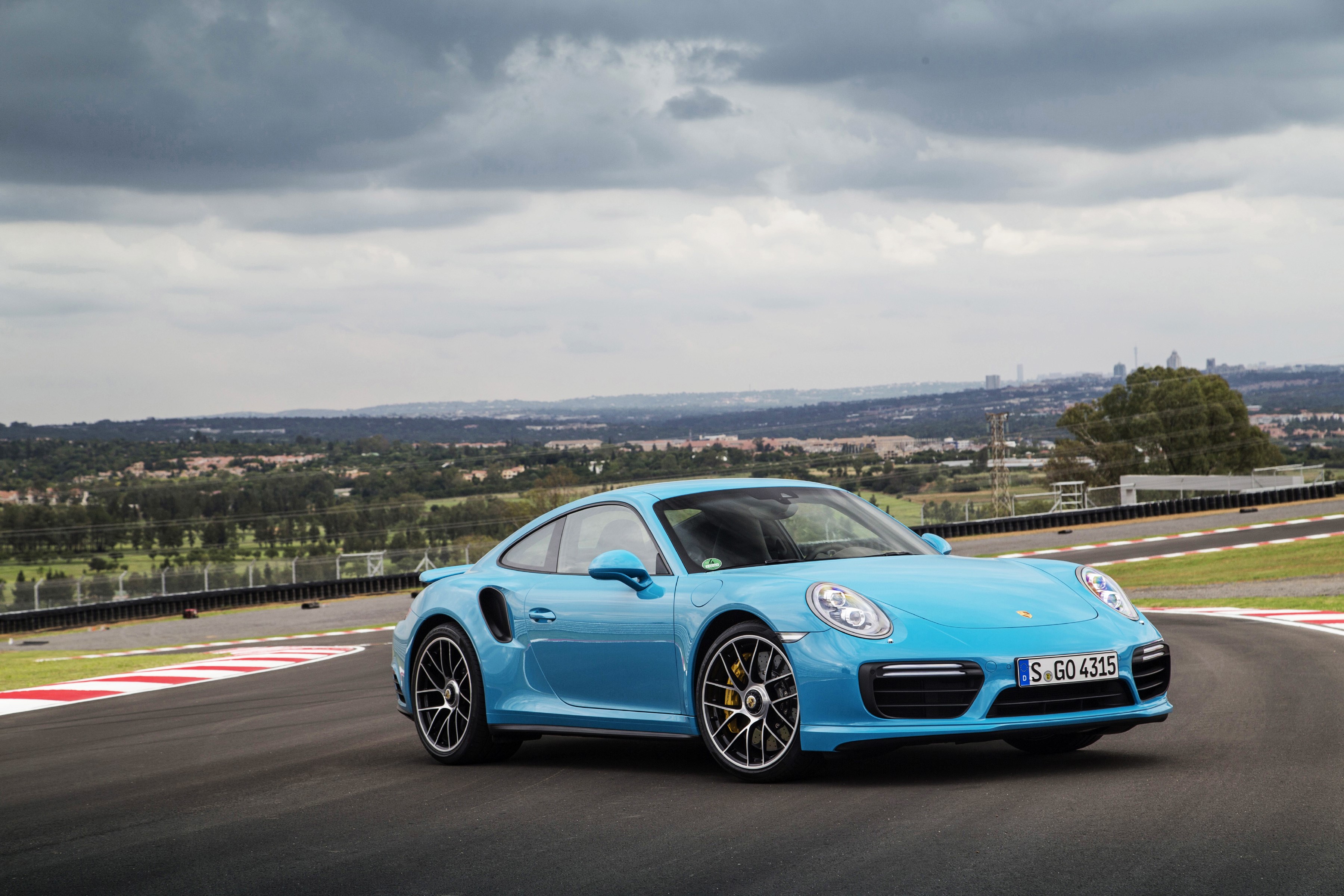 Light Blue Porsche 911 Turbo S Coupe on a Racetrack HD Wallpaper