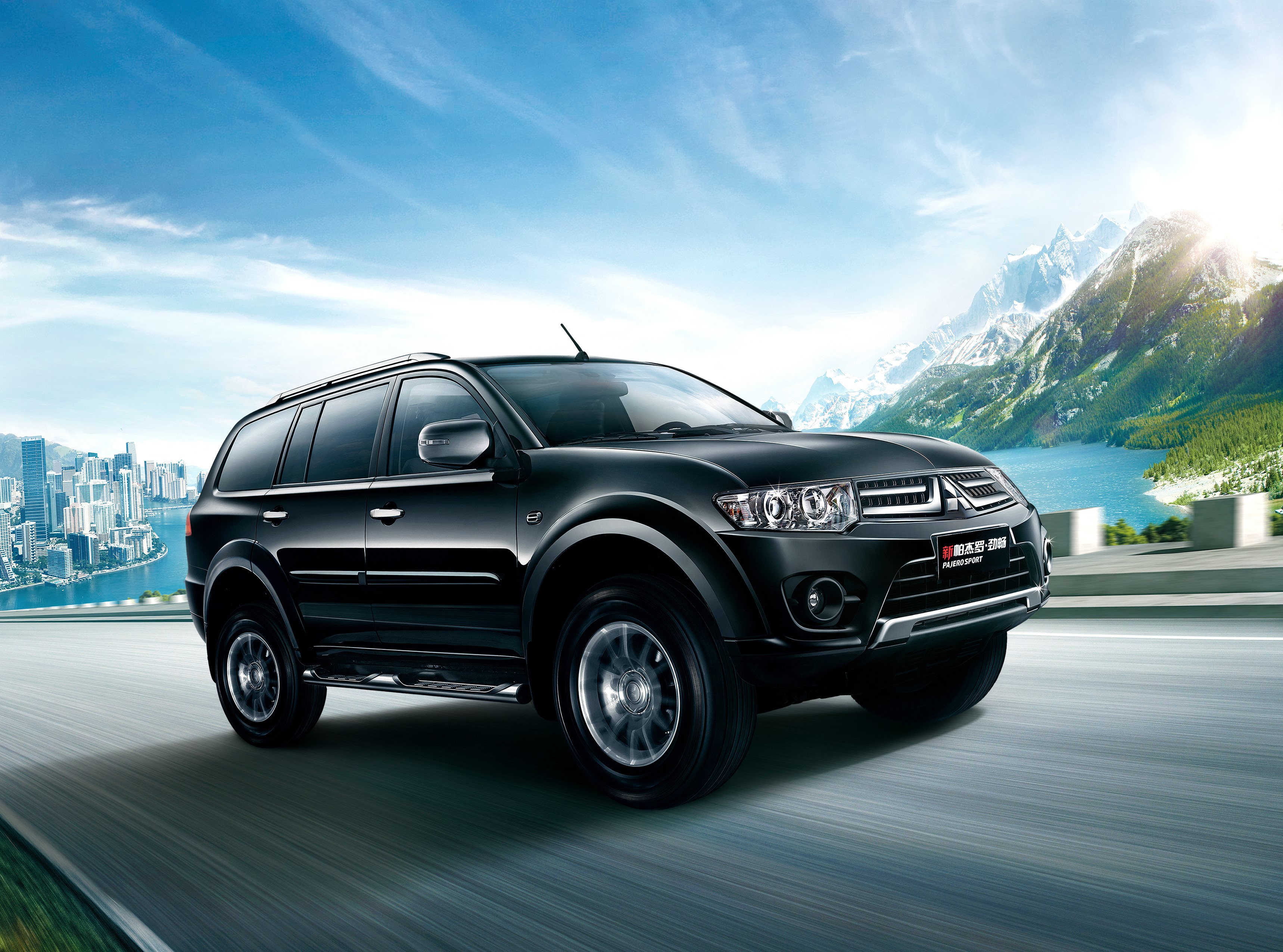 Black Mitsubishi Pajero Sport driving on a road HD Wallpaper