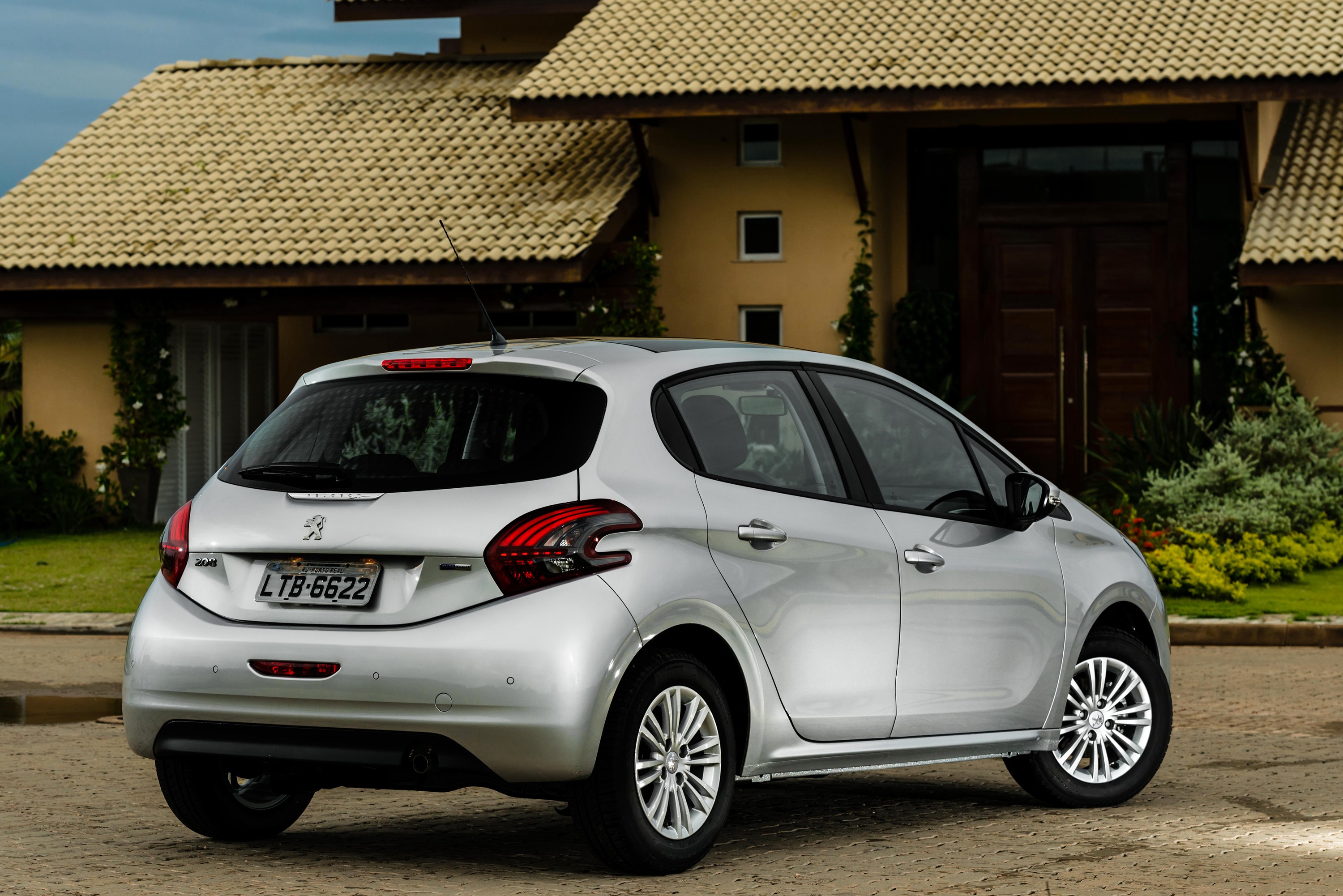 Silver Peugeot 208 Latam parked in front of a house HD Wallpaper