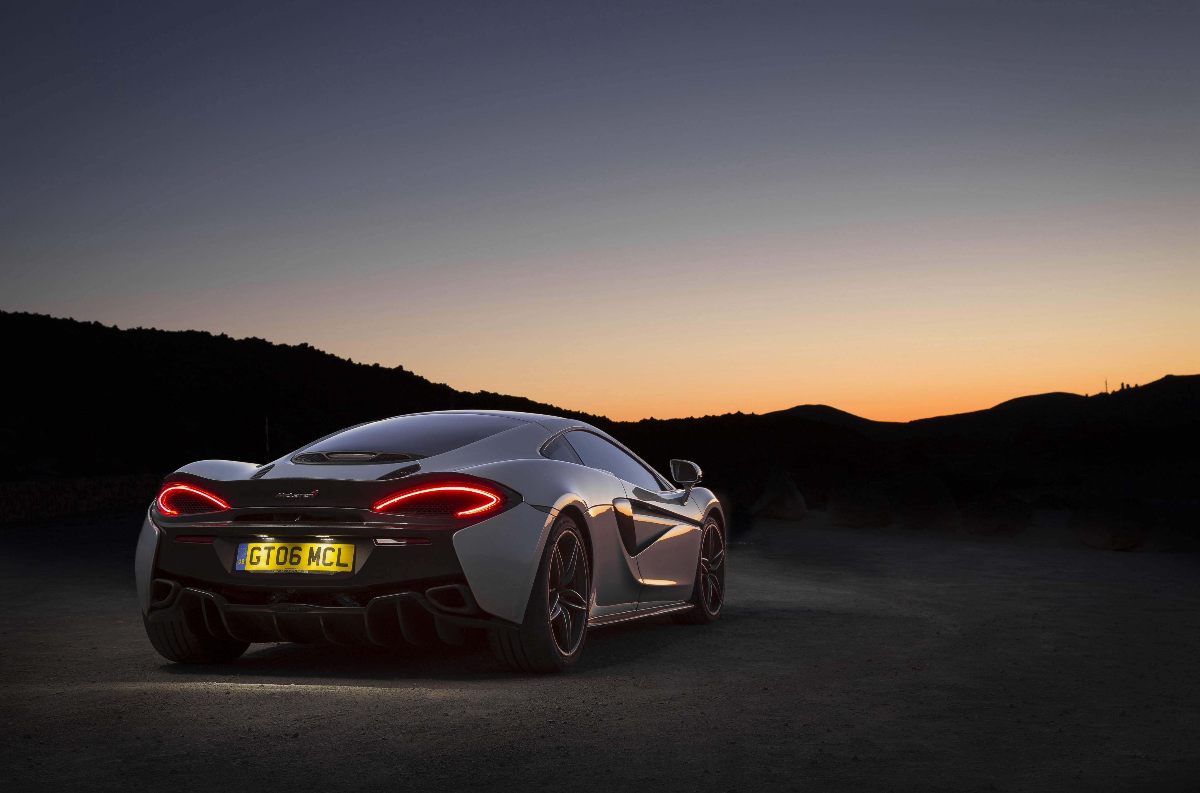 McLaren 570GT back view at dusk HD Wallpaper